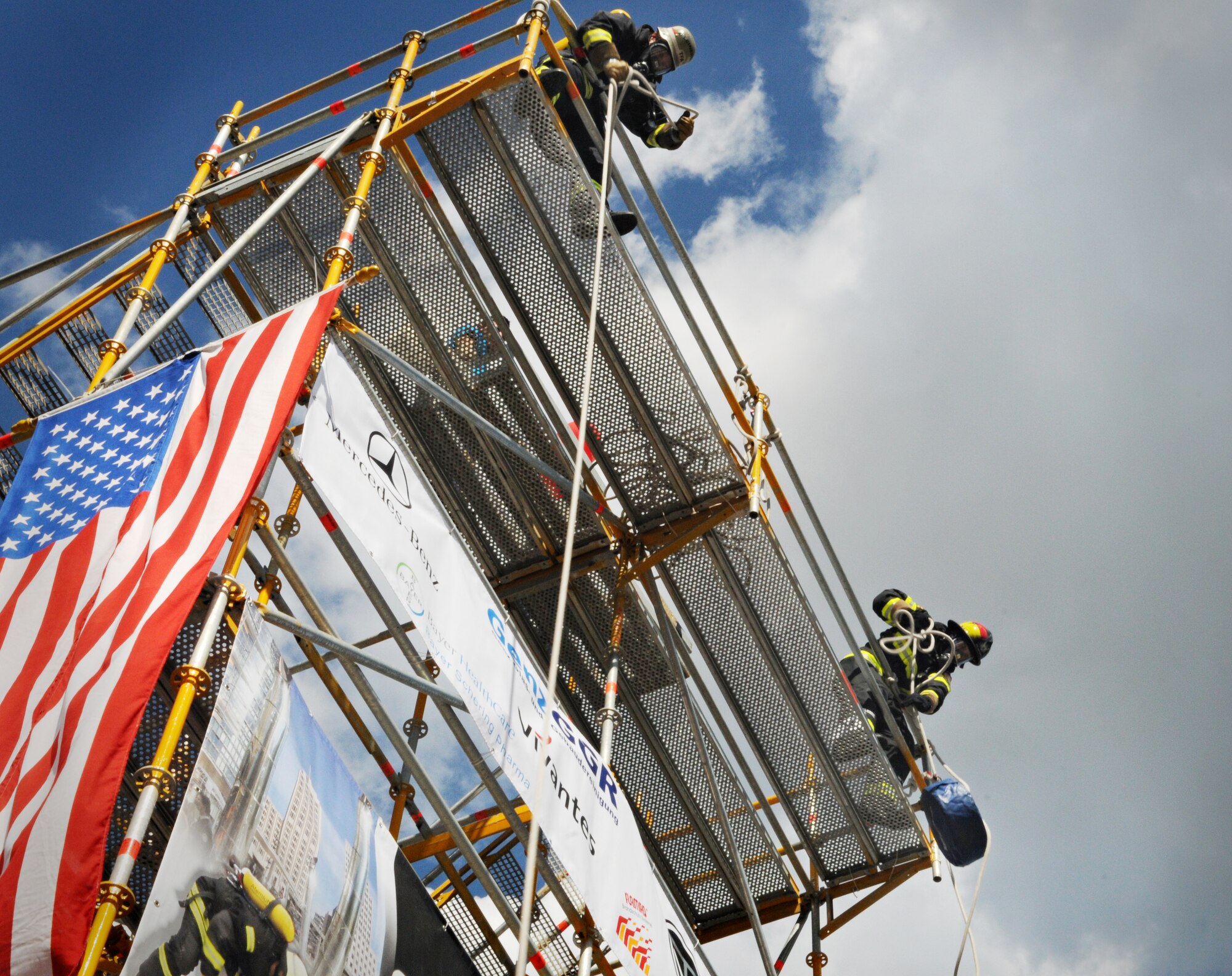 BERLIN – Senior Airman Aaron Anderson hoists a 45-pound hose from the top of a tower during a relay race in the fourth Berlin Firefighter Combat Challenge Sept. 4. Airman Anderson was part of Team Spangdahlem, which placed second in the relay event with a finish time of 1 minute, 36 seconds. (U.S. Air Force photo/Staff Sgt. Benjamin Wilson)