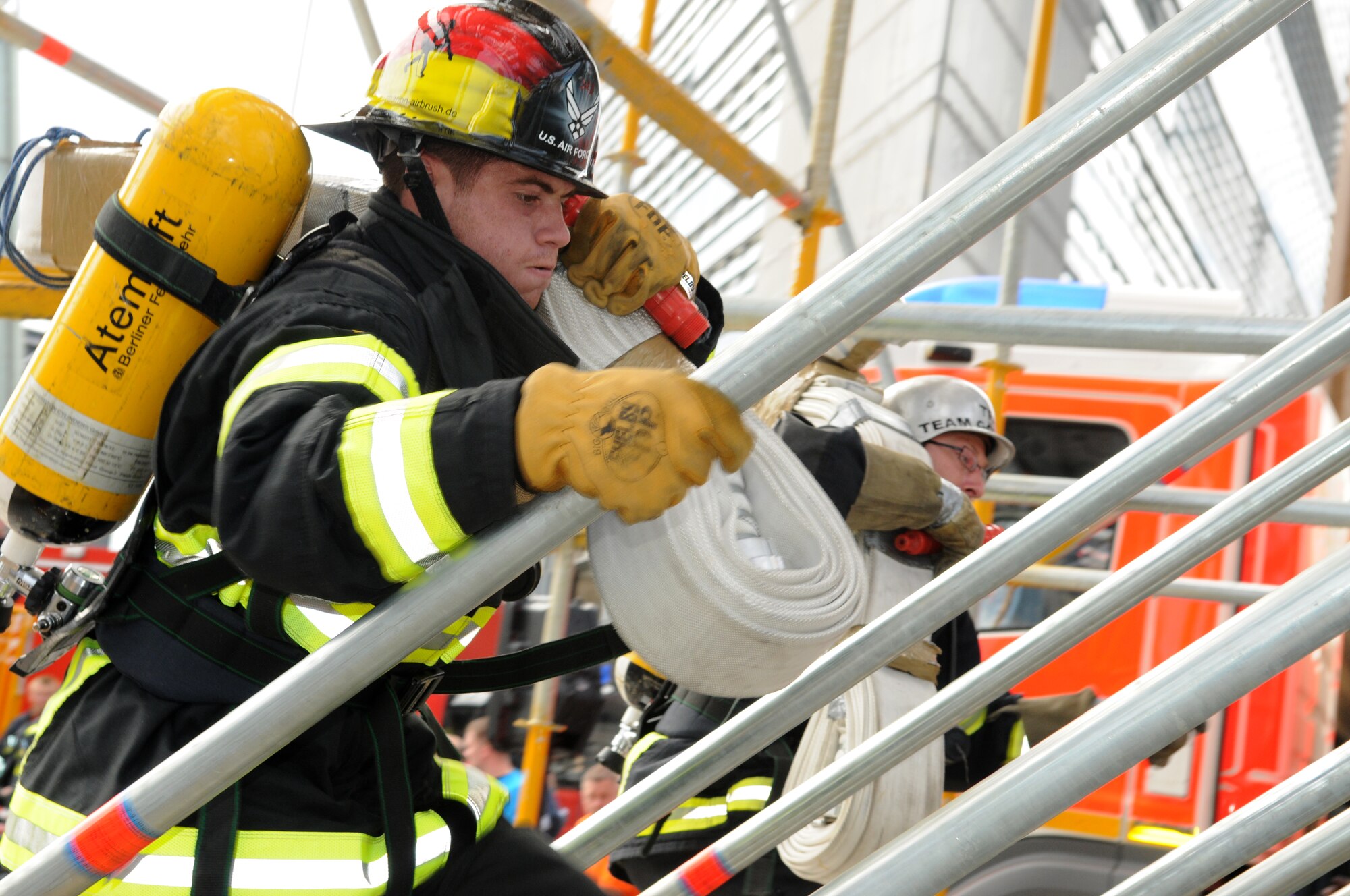 BERLIN – Airman Tyler Lamberson, 52nd Civil Engineer Squadron firefighter, sprints up the tower of an obstacle course during a team relay in the fourth Berlin Firefighter Combat Challenge Sept. 4. Airman Lamberson was one of six firefighters from Spangdahlem Air Base who competed in the event. (U.S. Air Force photo/Staff Sgt. Benjamin Wilson)