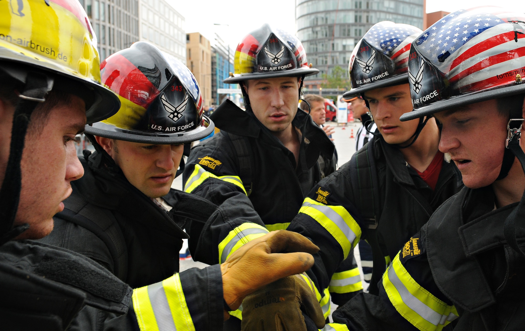 BERLIN – Firefighters from the Spangdahlem relay team huddle up before their race in the fourth Berlin Firefighter Combat Challenge Sept. 4. The Berlin FFCC consists of an obstacle course specifically designed to test the physical abilities of a firefighter. (U.S. Air Force photo/Staff Sgt. Benjamin Wilson)
