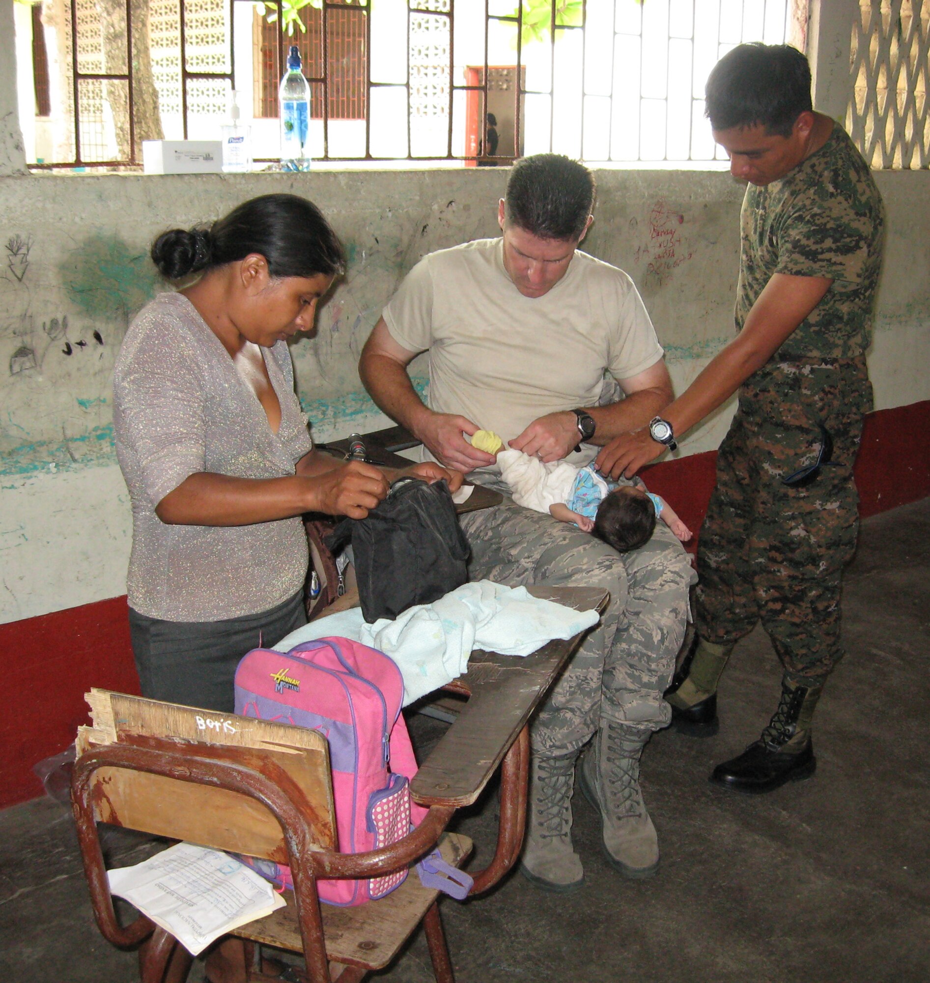 WRIGHT-PATTERSON AIR FORCE BASE, Ohio - Lt. Col. Jeff Beery, 445th Aerospace Medicine Squadron, provides pediatric care to a young child in Champerico, Guatemala, as part of the 2010 Guatemala Medical Readiness Training Exercise. (Courtesy photo) 