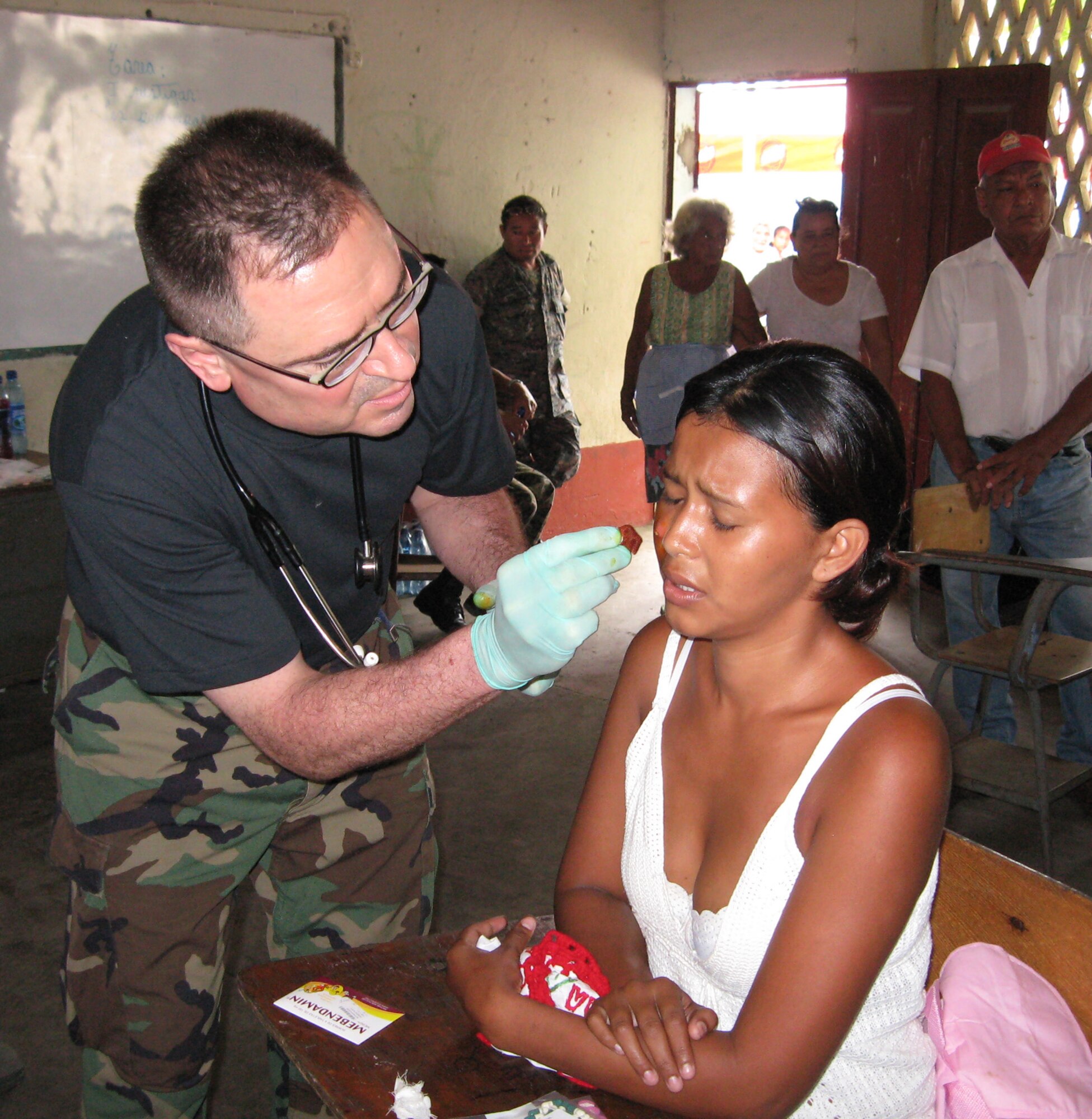 WRIGHT-PATTERSON AIR FORCE BASE, Ohio - Lt. Col. Peter DeRussy, 445th Aeromedical Staging Squadron, treats a young woman during the 2010 Guatemala Medical Readiness Training Exercise. (Courtesy photo) 