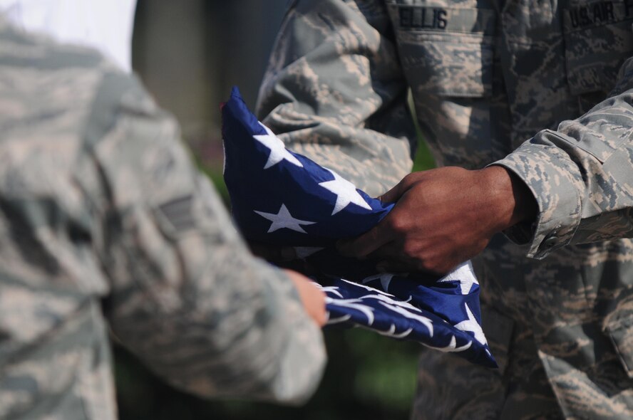 Senior Airmen Gabriela Diaz and Larico Ellis, 39th Medical Operations Squadron, fold a U.S. flag during a Patriot Day retreat ceremony Sept. 10, 2010 at Incirlik Air Base, Turkey.   The ceremony recognized the service of first responders and included a moment of silence and taps to honor those who lost their lives during the Sept. 11 attacks.  (U.S. Air Force photo by Senior Airman Ashley Wood/Released)