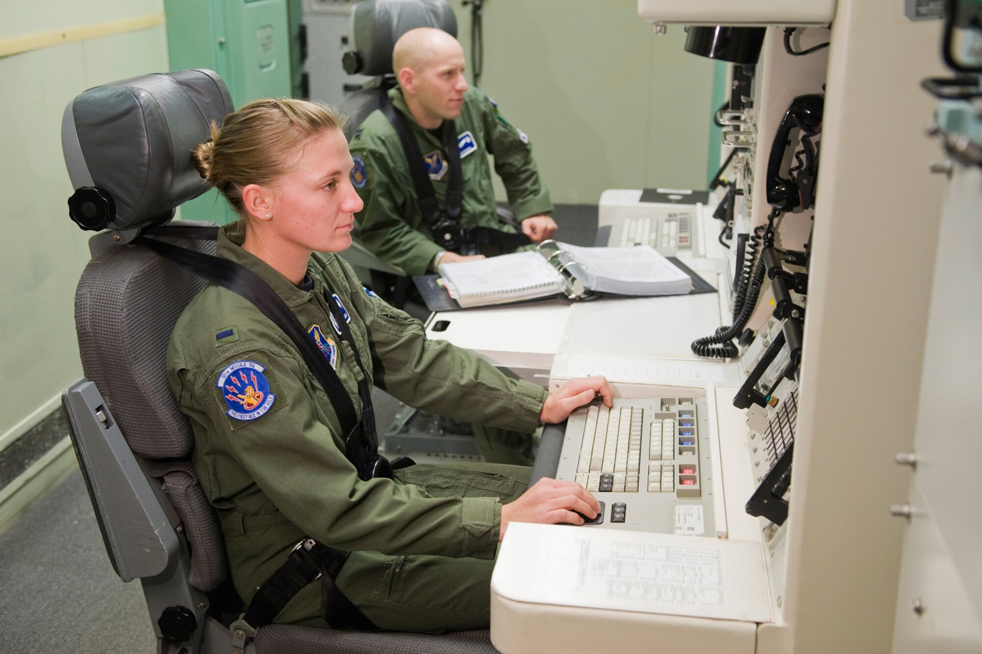 Members of the 10th Missile Squadron Guardian Challenge Team, 1st Lt. Megan Steele and Capt. Colin Merrin, practice possible competition scenarios in the missile procedures trainer Sept. 1. (U.S. Air Force photo/Beau Wade)