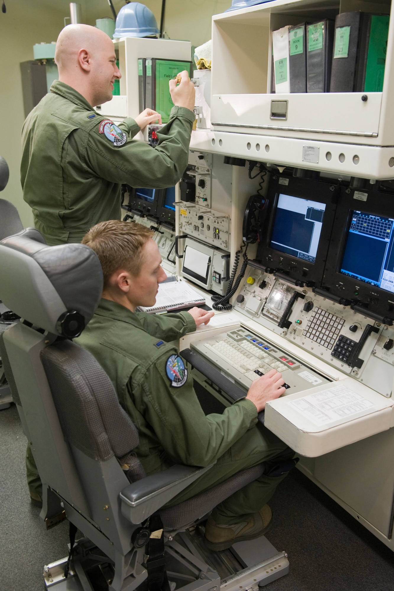 The 12th Missile Squadron selected 1st Lts. Adam Hamlin (seated) and Matthew Berry to represent them Sept. 20-24 during the Operations and Maintenance portions of the inagural Global Strike Challenge competition set to take place here at Malmstrom. (U.S. Air Force photo/Beau Wade)