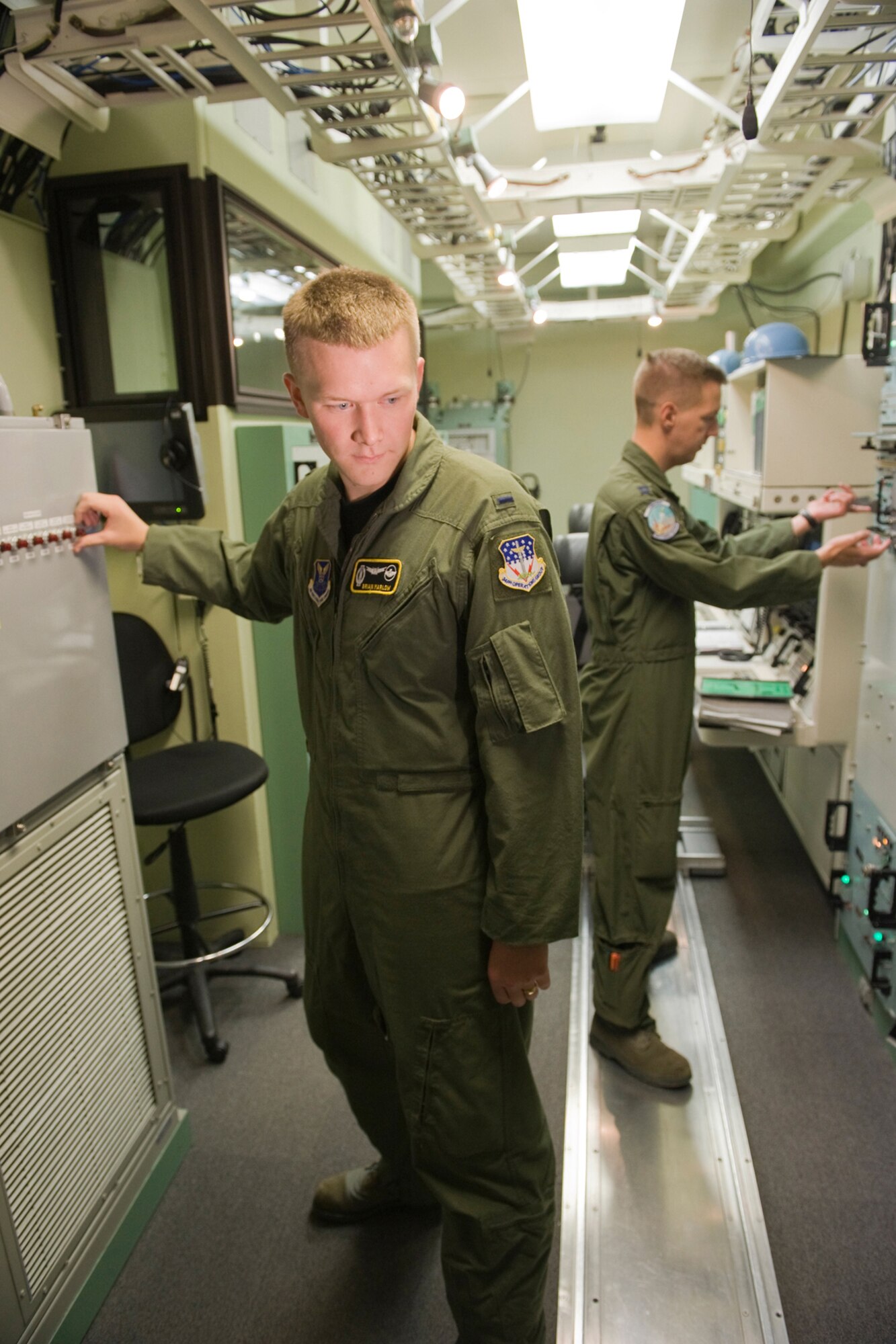 Capt. Kevin Hullihan (hackground) and 1st Lt. Brian Marlow, check the settings on the equipment in the missile procedures trainer Sept. 1 while getting in some practice for the upcoming Global Strike Challenge competition. The pair of missileers will represent the 490th Missile Squadron during the event. (U.S. Air Force photo/Beau Wade)