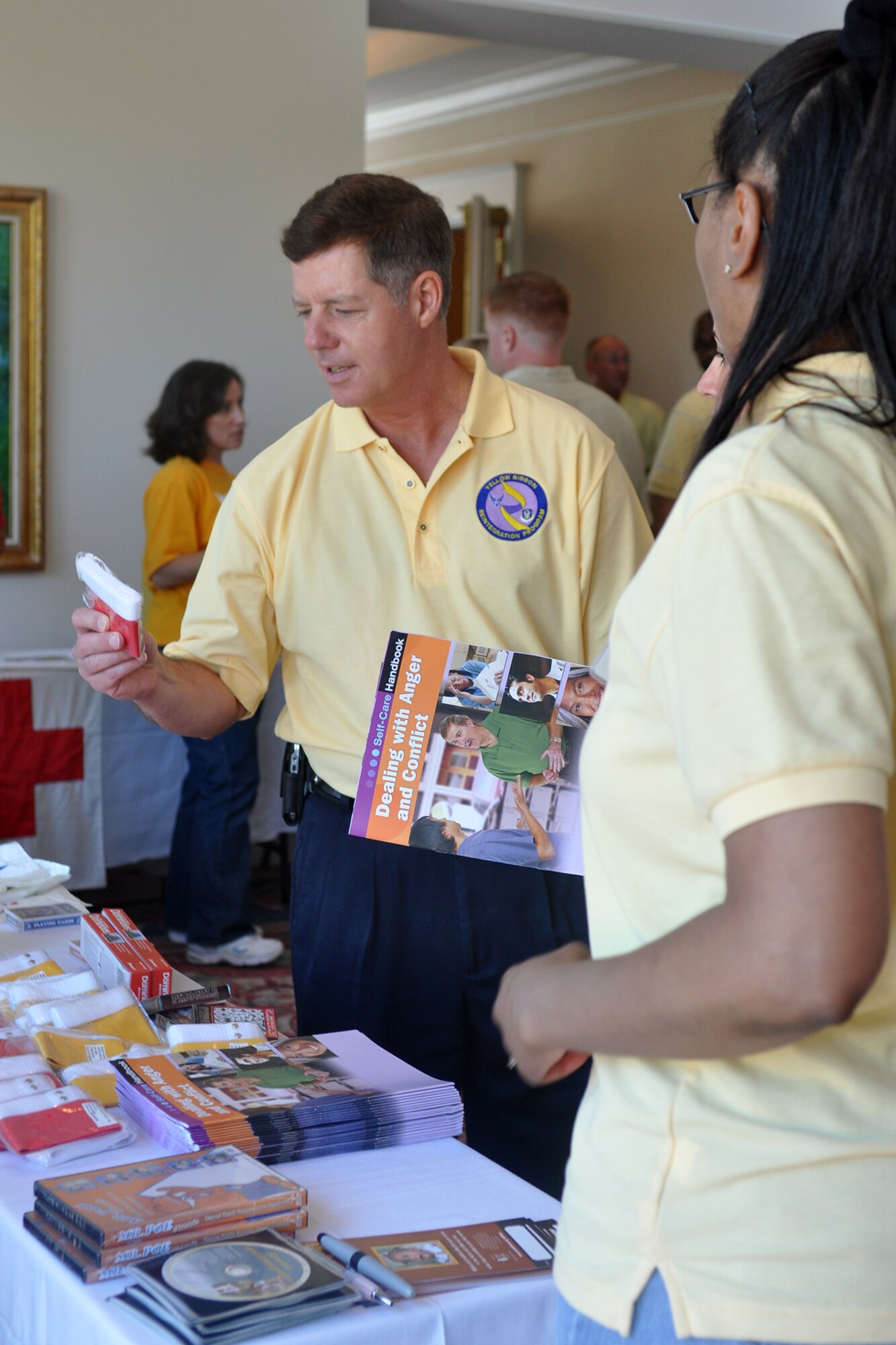 Col. Keith Schultz, 917th Operations Group commander, examines informational literature after welcoming attendees to a Yellow Ribbon Program event at the Cypress Bend Resort, Many, La., Aug. 13, 2010. Recently deployed members of the 917th Wing and their families received the opportunity to talk, learn and connect with other recently-deployed members and representatives and volunteers from various Department of Defense organizations during their weekend. The YRP, a tasking from the Department of Defense, aids in reintegrating Soldiers, Sailors, Airmen and Marines back to their state-side lives after returning from a deployed environment. (U.S. Air Force photo/Senior Airman Crystal Jordan)