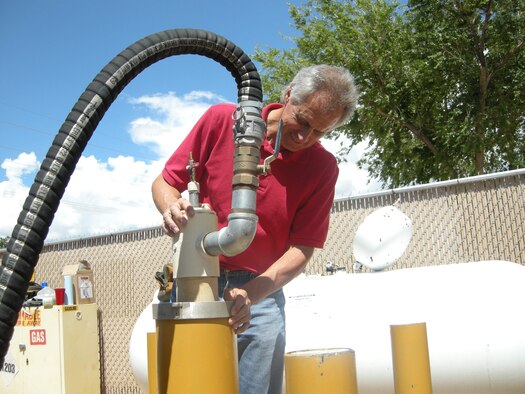 Mark Holmes, 377th Civil Engineering Division, checks KAFB 1065, the monitoring well that indicated 1.4 feet of petroleum on the groundwater in February 2007.  U.S. Air Force Photo by Michael Kleiman..