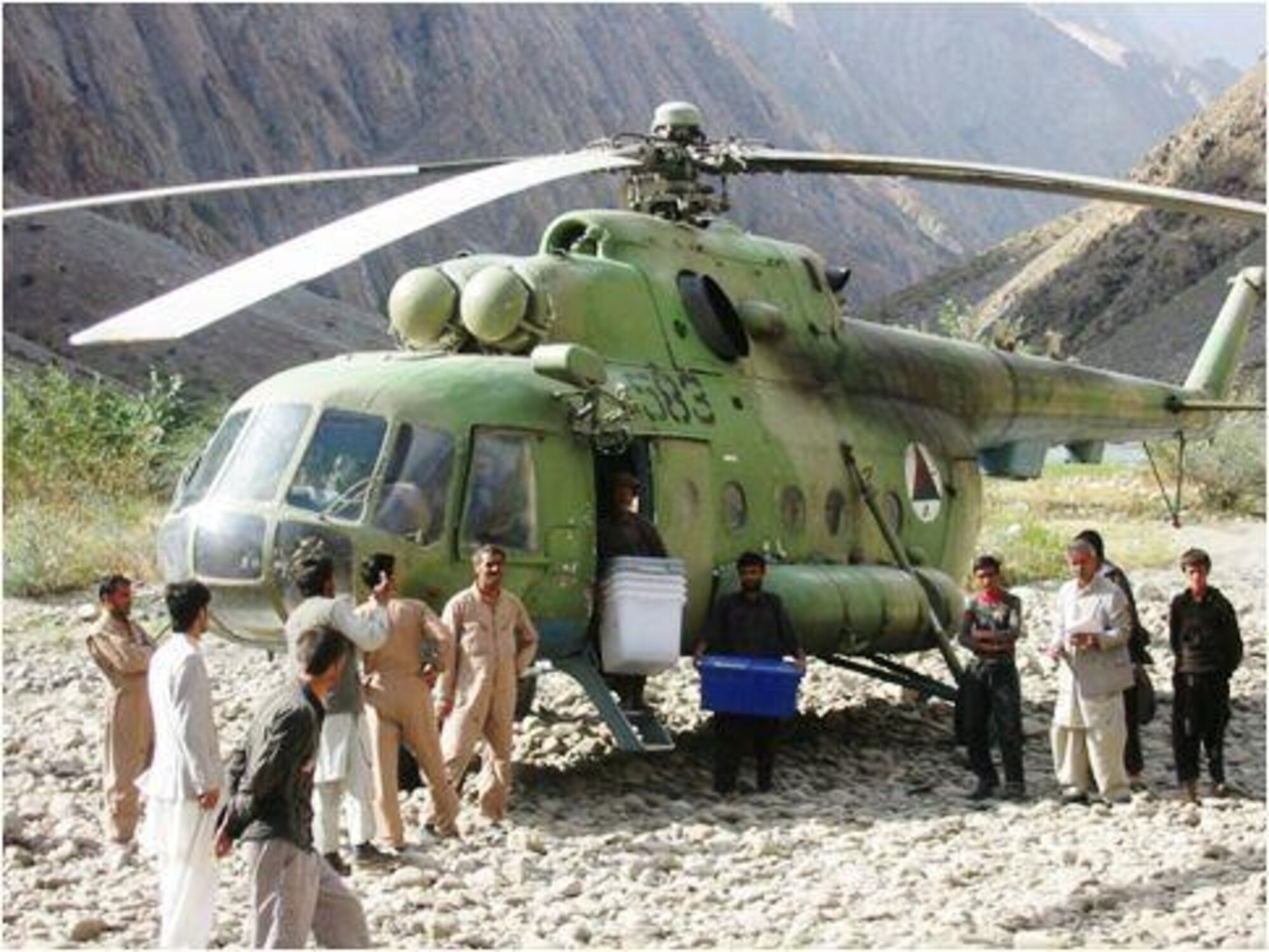 Members of the Afghan Air Force begin unloading election material in Northern Afghanistan during mid-September, 2010.  (U.S, Military photo/RELEASED).