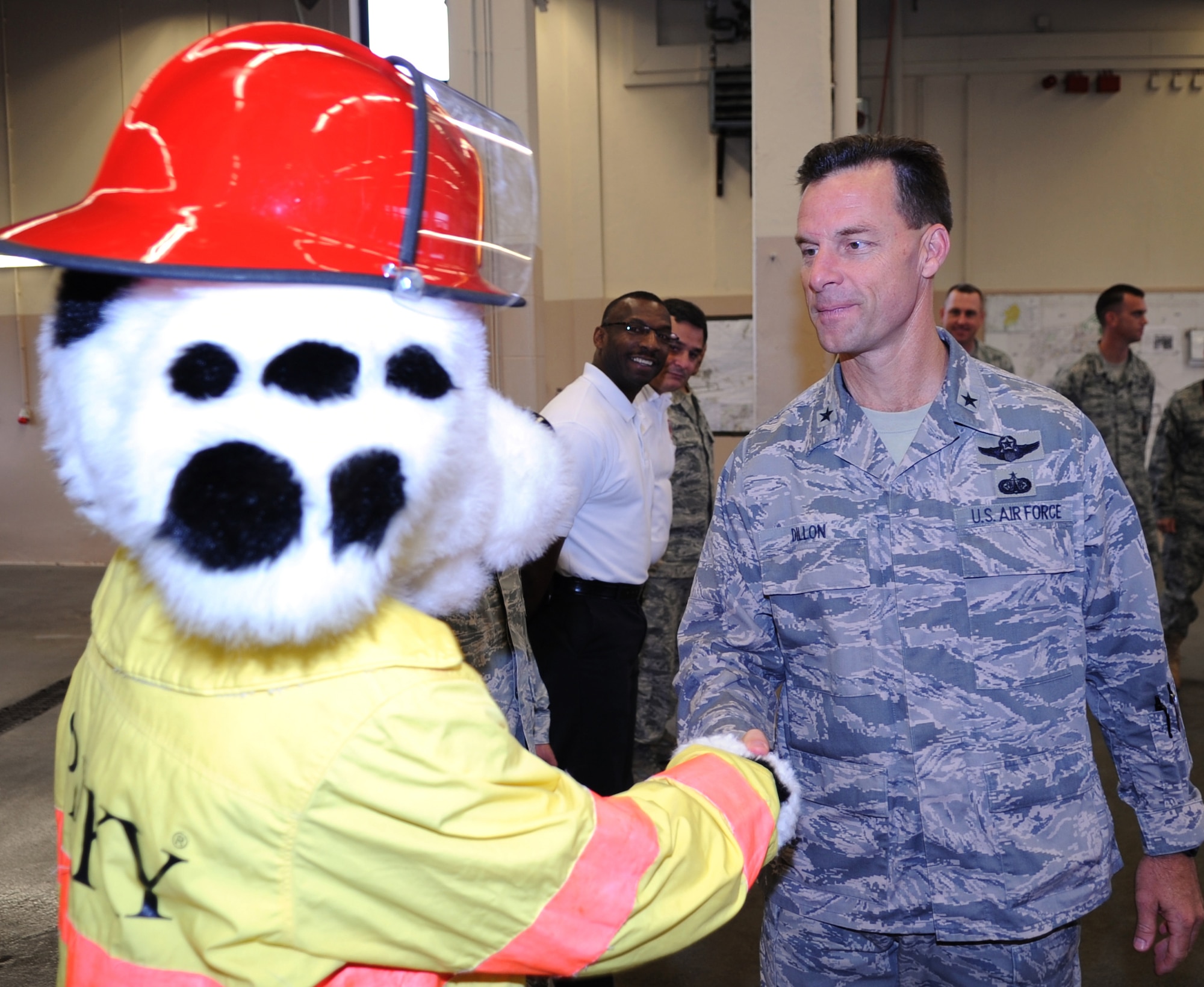 U.S. Air Force Brig. Gen. Mark Dillon, 86th Airlift Wing commander, shakes hand with Sparky the Fire Dog from the 886th Civil Engineer Squadron firefighters after signing the Kaiserslautern Military Community Proclamation, Ramstein Air Base, Germany, Sept. 10, 2010. The signing of the proclamation was to start National Fire Prevention Week, Oct 3-9, with the first week focusing on, "Beep! Beep! Beep! Smoke Alarm; a sound you can live with". (U.S. Air Force photo by Senior Airman Caleb Pierce)