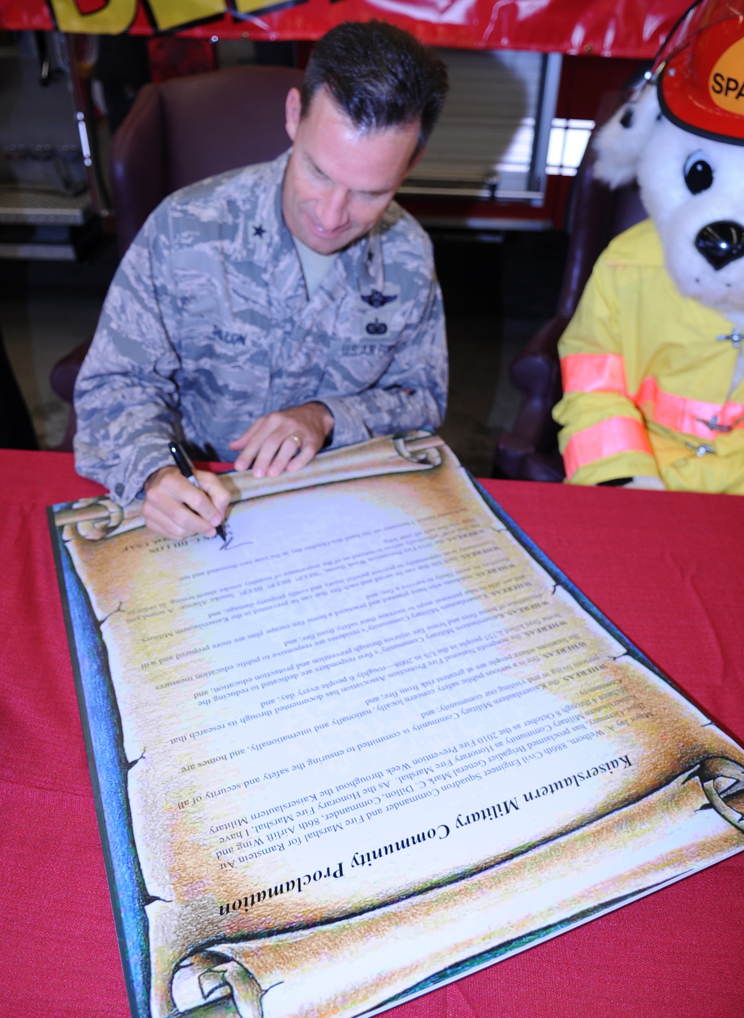 U.S. Air Force Brig. Gen. Mark Dillon, 86th Airlift Wing commander, signs the Kaiserslautern Military Community Proclamation, Ramstein Air Base, Germany, Sept. 10, 2010. The signing of the proclamation was to start National Fire Prevention Week, Oct 3-9, with the first week focusing on, "Beep! Beep! Beep! Smoke Alarm; a sound you can live with". (U.S. Air Force photo by Senior Airman Caleb Pierce)