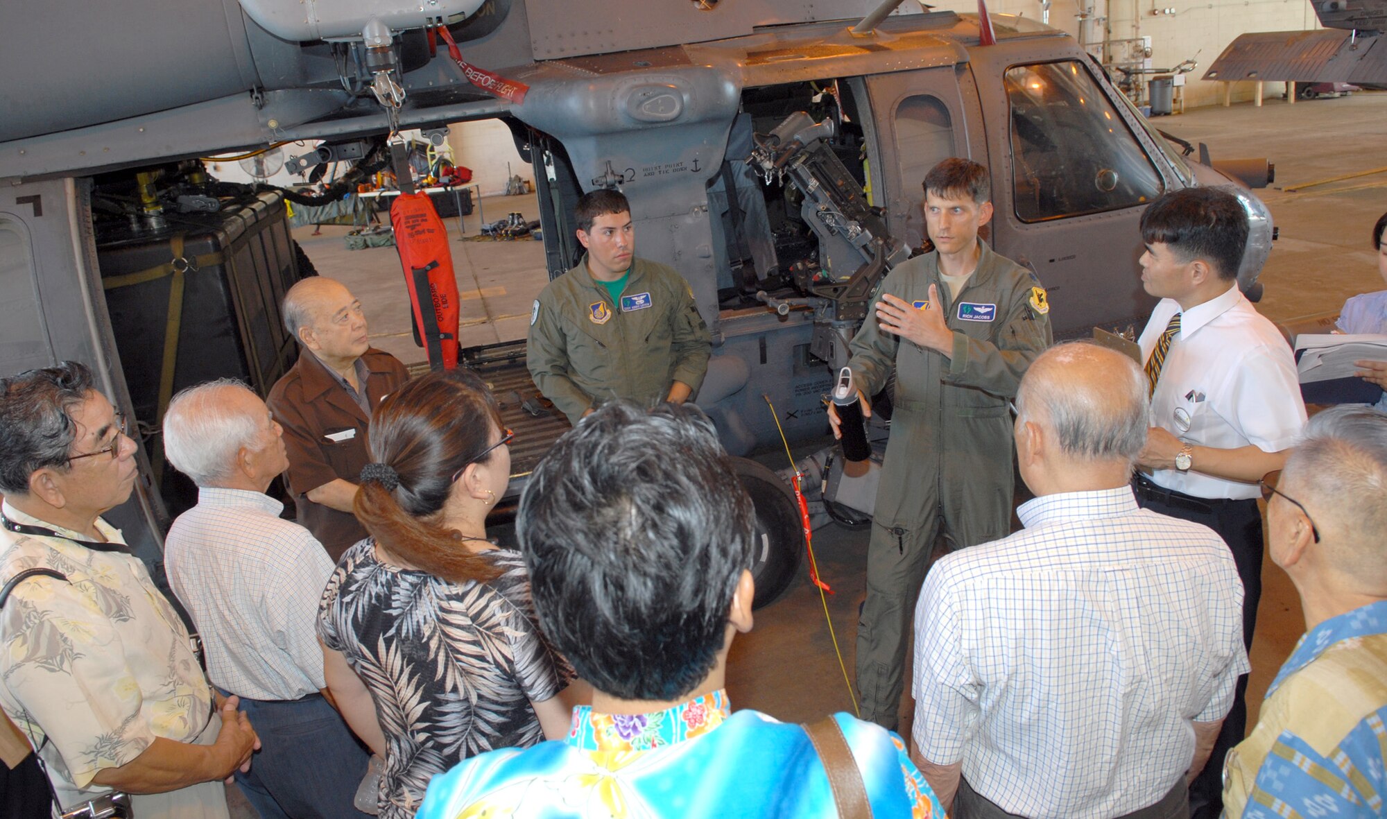 Lt.Col. Richard Jacobs, assistant director of operations for the 33d Resque Squadron, shows off and HH-60 Pavehawk during the Kadena Co-Commanders' tour Sept. 10. Dozens of local leaders toured the base as part of the Kadena Co-Commanders' tour to gain better understanding of Kadena operations and people. (U.S. Air Force photo / Junko Kinjo)
