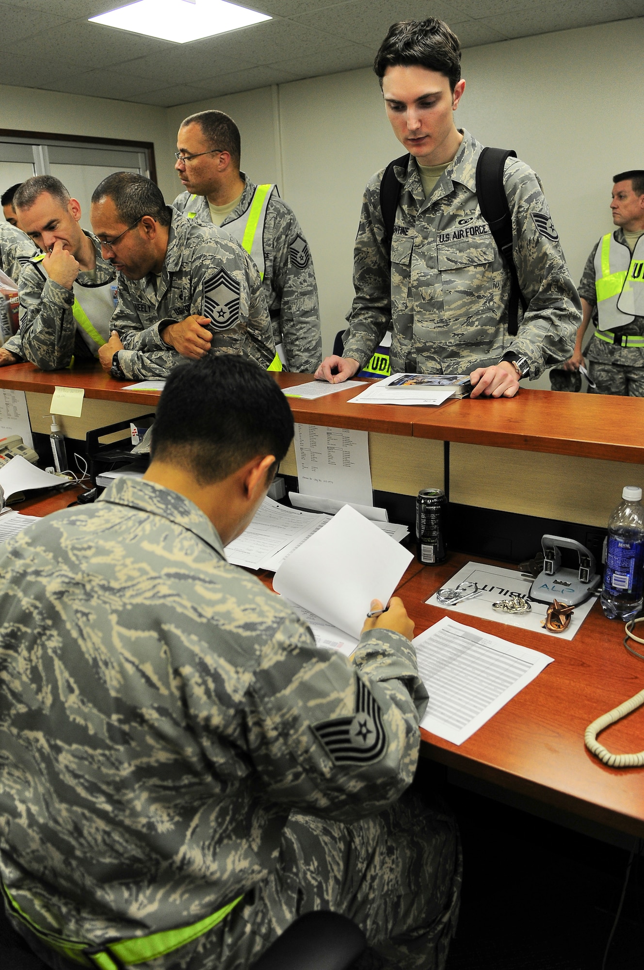 YOKOTA AIR BASE, Japan -- Airmen at Yokota Air Base process through a personnel deployment function line, 9 Sep., during an Operational Readiness Exercise. The deployment line provided the means to ensure Airmen are completely prepared prior to departing for a deployment. The exercise gave units an opportunity to test their ability to expeditionary deploy. (U.S. Air Force photo by Staff Sgt Stacy Moless)