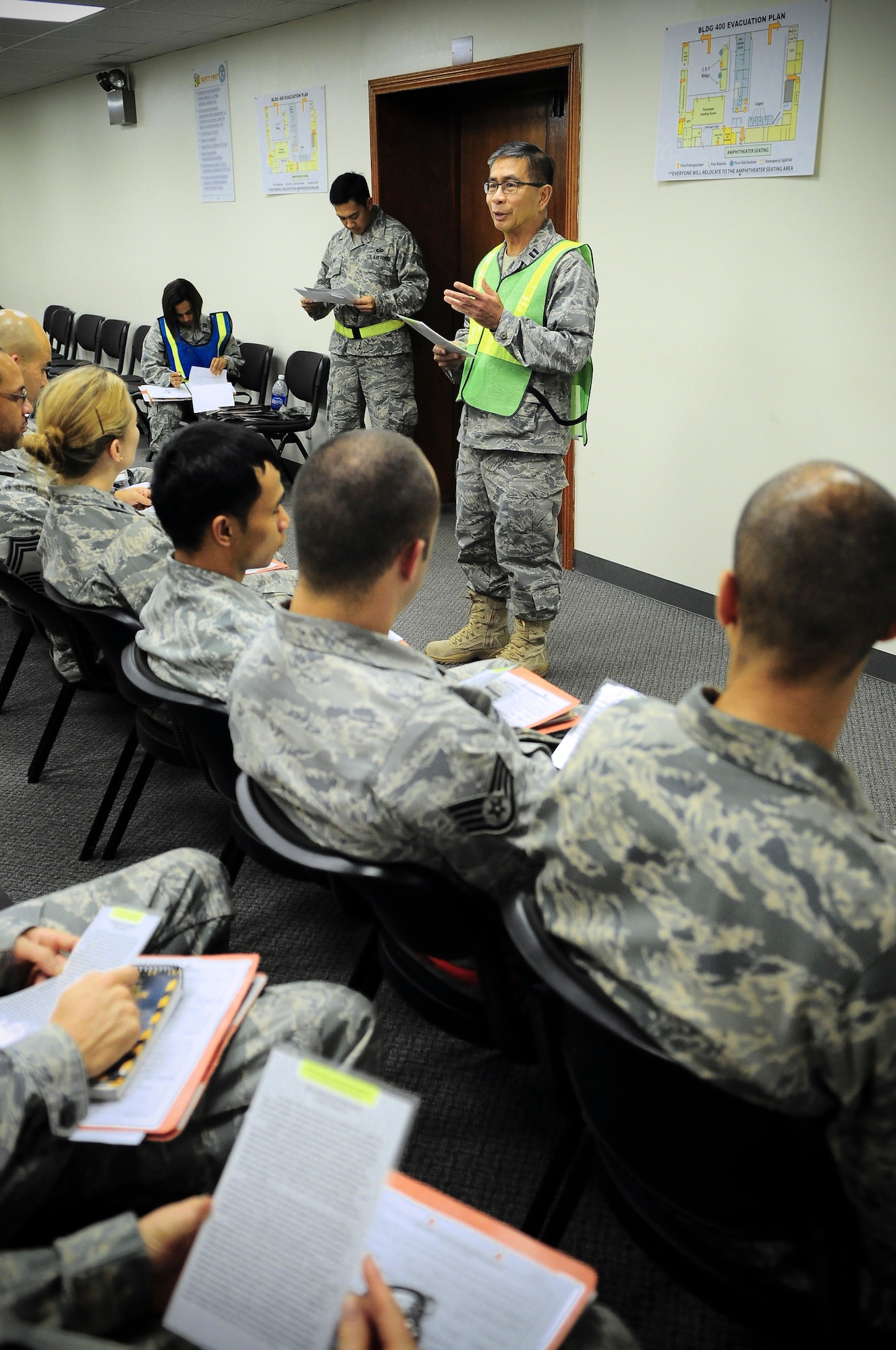 YOKOTA AIR BASE, Japan -- Capt. Albert Sanchez, 374th Airlift Wing chaplain, gives a briefing to Airmen during their processing for a simulated deployment during an Operational Readiness Exercise, Sep. 9. The exercise tested the 374th Airlift Wing’s capabilities to rapidly deploy members and equipment. (U.S. Air force photos by Staff Sgt Stacy Moless)