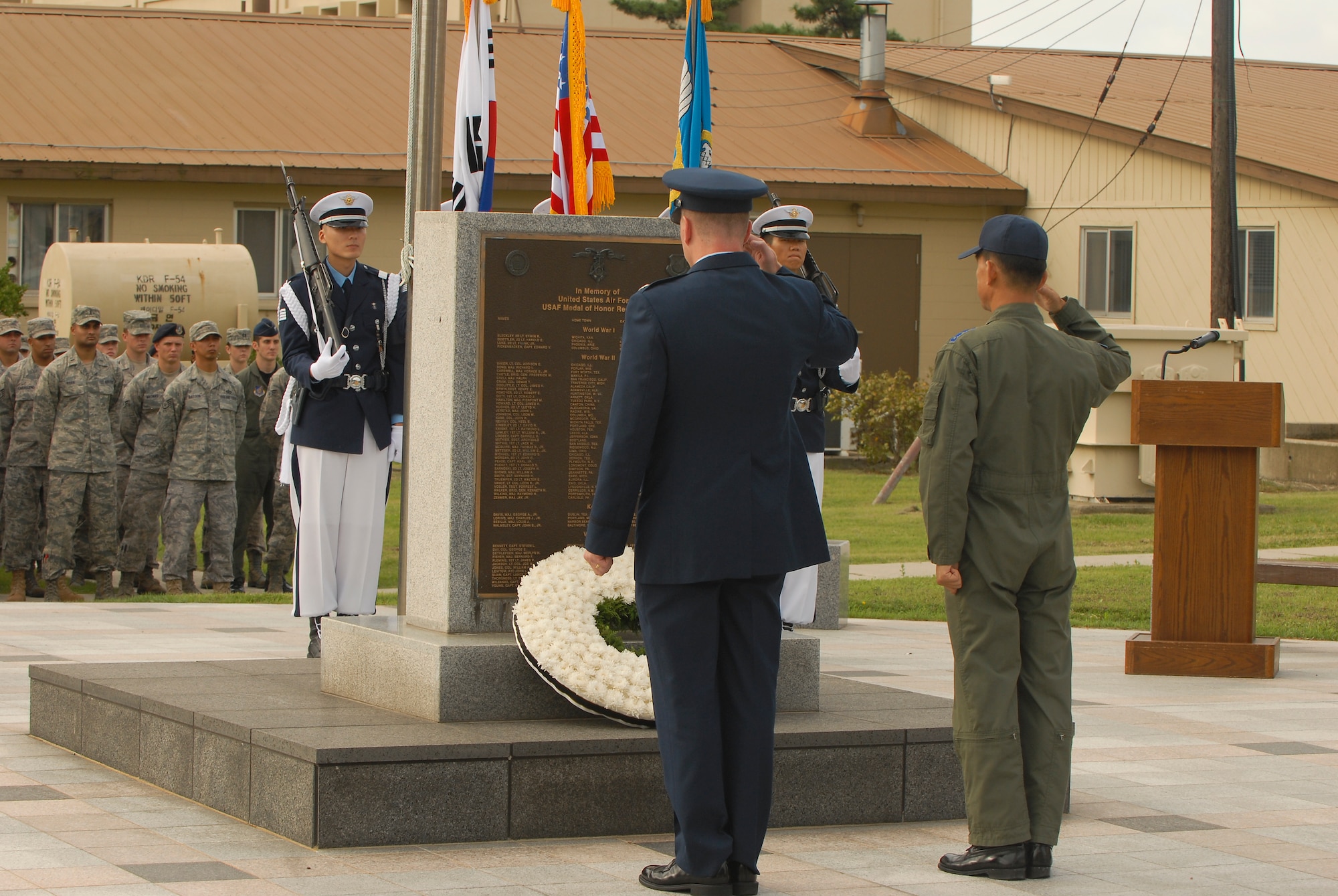 KUNSAN AIR BASE, Republic of Korea -- Col. John Dolan, 8th Fighter Wing commander, and Col. Choi Jae-Hun, Republic of Korea Air Force 38th Fighter Group commander, salute a memorial wreath Sept. 10 during the wing's Sept. 11 Patriot Day Remembrance Ceremony. The ceremony was in honor of the victims from Flights 11, 175, 77, 93, the Pentagon, the World Trade Center North and South tower employees, and emergency service workers, who were killed in the events in America Sept. 11, 2001. (U.S. Air Force photo/Senior Airman Ciara Wymbs)
