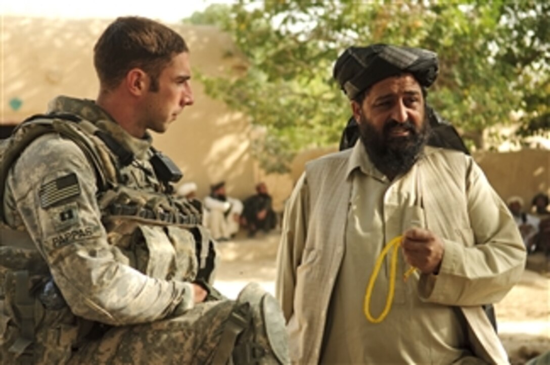 U.S. Army Capt. Maxwell Pappas (left), district support unit leader of the Zabul Provincial Reconstruction Team, speaks with Shah Joy district Chief Abdul Qayum before a shura near Forward Operating Base Bullard in Zabul province, Afghanistan, on Sept. 7, 2010.  During the shura, Qayum spoke to elders about the upcoming provincial parliamentary elections.  