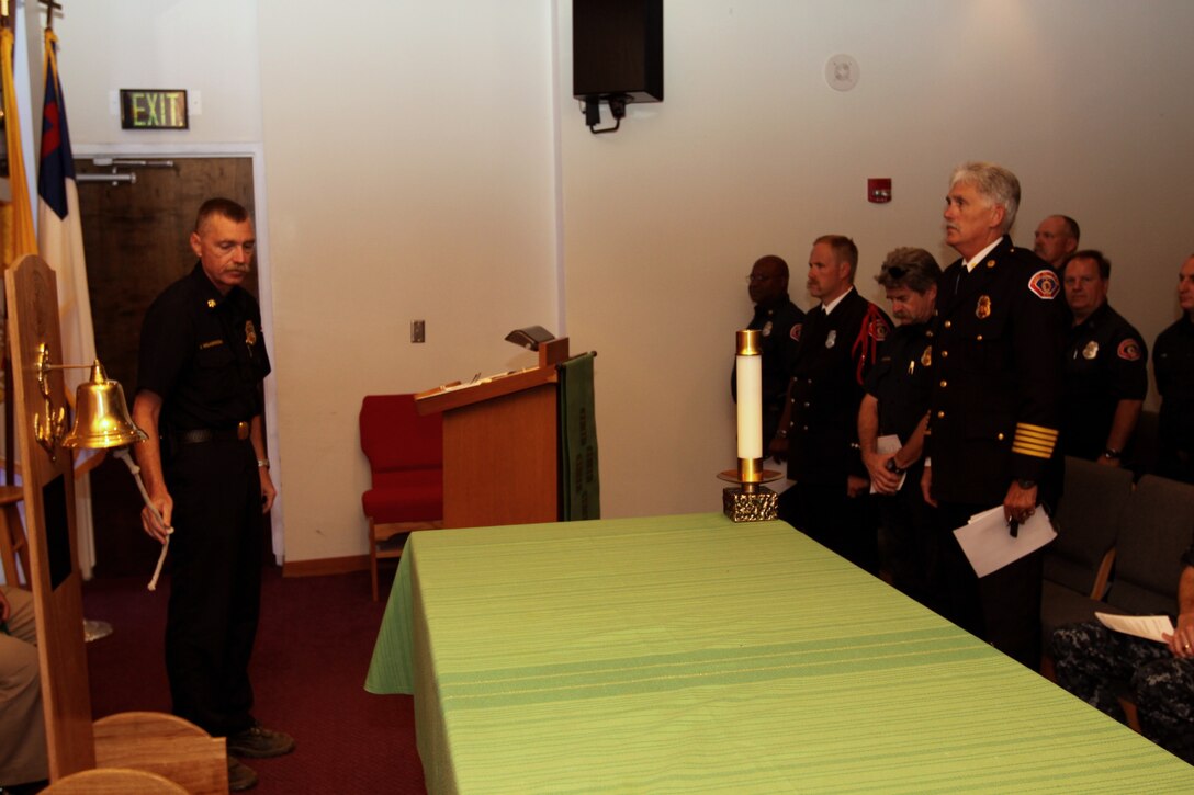 Jeffrey L. Wilkerson (left), deputy fire chief, Camp Pendleton Fire and Emergency Services, conducts the “Four-Fives” bell ceremony in honor of the fallen members of the New York Fire Department, at Camp Pendleton’s Naval Hospital Chapel, Sept. 10. The Four-Fives bell ceremony is a tradition in the fire service which symbolizes that that a firefighter died in the line of duty. The custom has continued down to present day and the rendering of final honors to departed comrades by ringing the bell for five times repetitions for four repetitions.