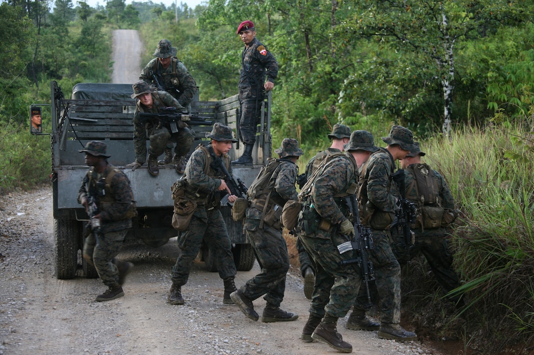 A Guatemalan Army Special Forces or "Kaibil" officer observes how U.S. Marines conduct a jungle patrol exercise at Poptun Training Camp in Poptun, Guatemala, Sept. 11.  Patrolling in jungle terrain was part of the subject-matter expert exchange between Kaibil soldiers and Marines of Special-Purpose Marine Air-Ground Task Force Continuing Promise 2010.