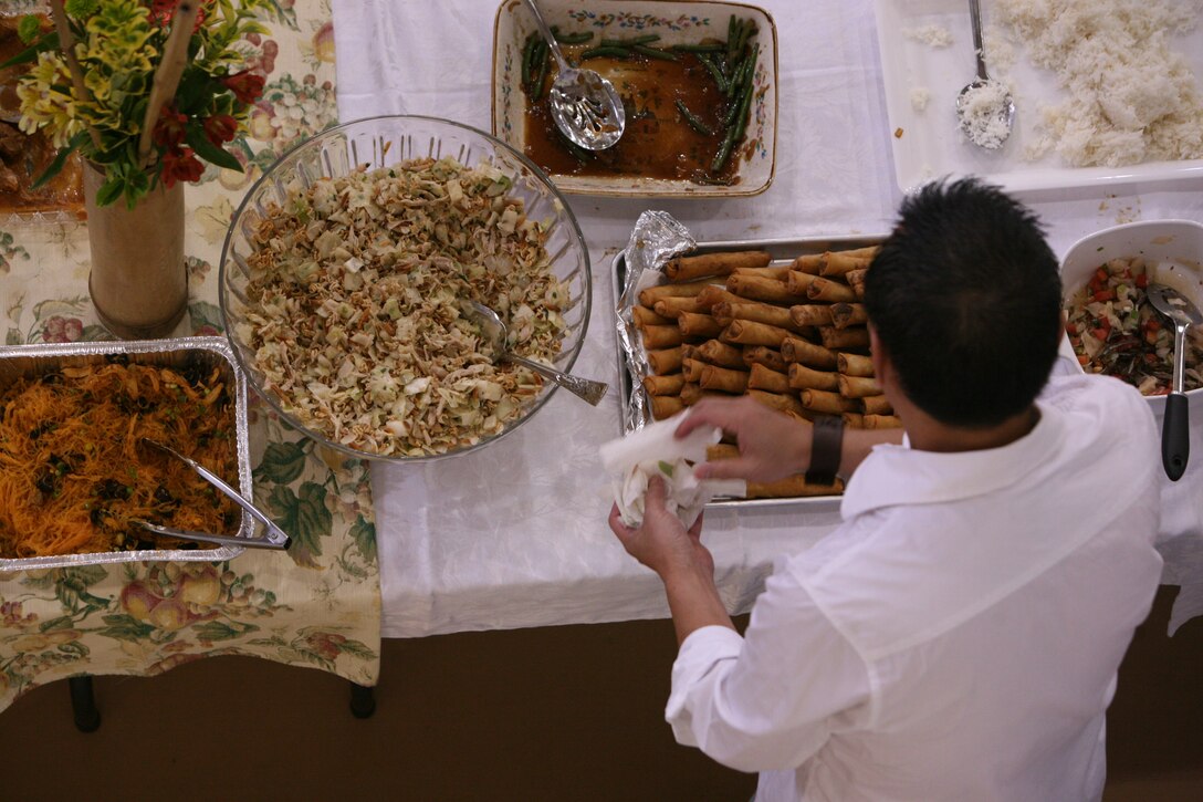 A parishioner at Annunciation Parish in Havelock, N.C., helps himself to some food during a memorial event Sept. 11. The church event offered food, dancing and prayer in commemoration of the terrorist attacks of Sept. 11.