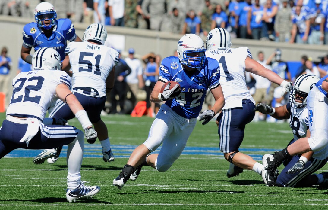 Falcons running back Jared Tew breaks through the Cougars' defensive line during the Air Force-BYU game at Falcon Stadium Sept. 11, 2010. Tew, a native of Park City, Utah, had 17 rushes for 77 yards, averaging 4.5 yards per carry in Air Force's 35-14 victory. (U.S. Air Force photo/J. Rachel Spencer)