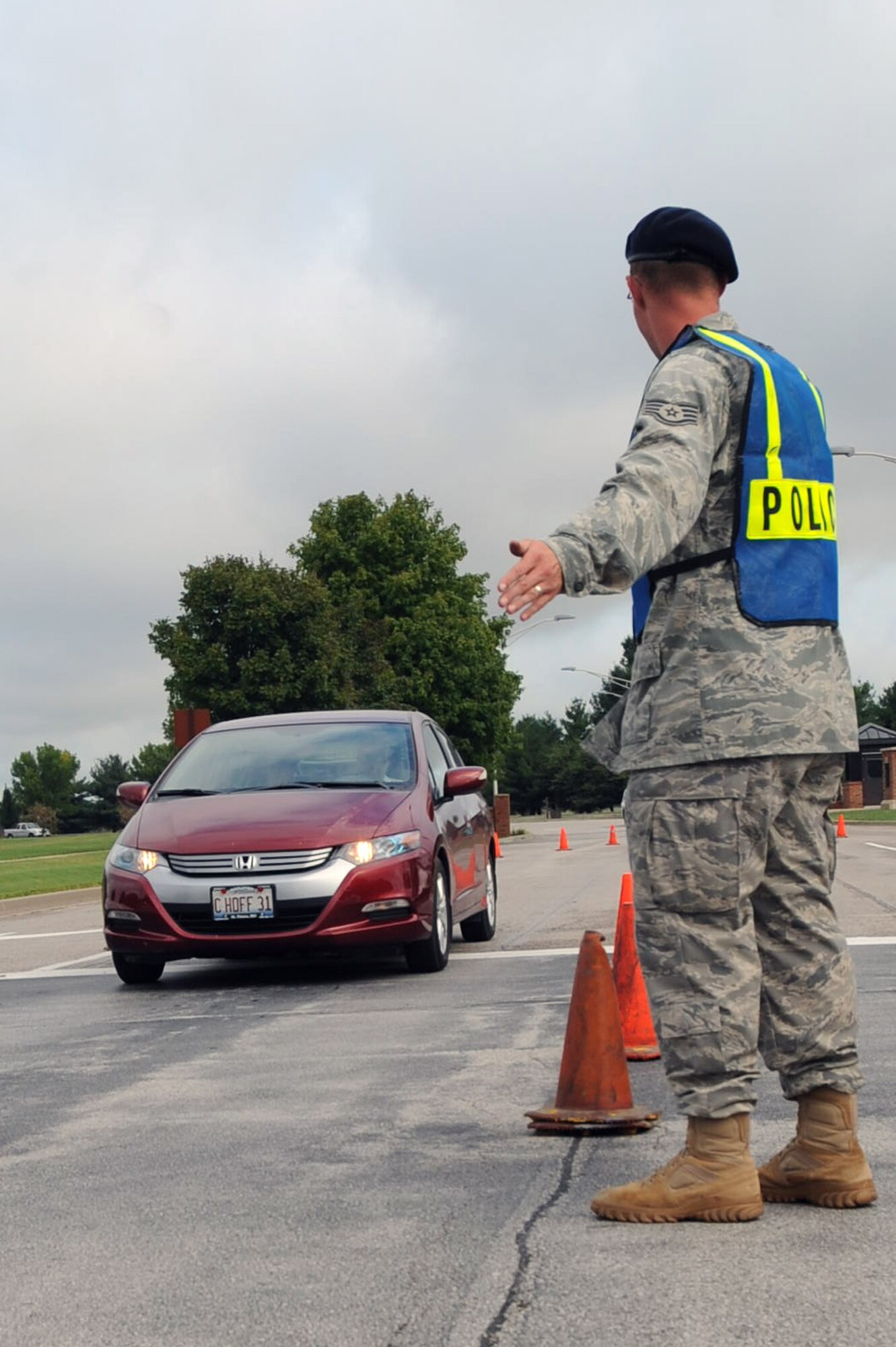 SCOTT AIR FORCE BASE, Ill. -- Staff Sgt. Shawn Carroll, 375th Security Forces Squadron, directs traffic as they enter the Shiloh Gate for the 2010 Airpower Over the Midwest Air Show. The 375th SFS and several augmentees provided base security along with guidance for visitors during the airs how Sept. 11. (U.S. Air Force photo/Tech. Sgt. Michelle Larche)