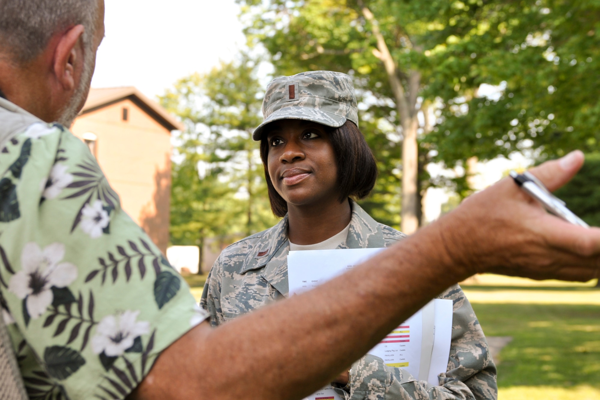 YOUNGSTOWN AIR RESERVE STATION, Ohio -- U.S. Air Force Reserve 2nd Lt. Danielle C. Williams, 910th Force Support officer in charge of the Junior Reserve Officer Training Corps encampment here, speaks with Vindicator photographer Bill Lewis behind a lodging building here, Aug. 20, 2010. Approximately 23 JROTC cadets from East Technical High School in Cleveland, Green High School in Uniontown, and Trumbull Career and Technical Center in Warren, are participating in the 5-day encampment to learn leadership, teamwork, respect for others and the Air Force core values. U.S. Air Force photo by Senior Airman Brenda Haines