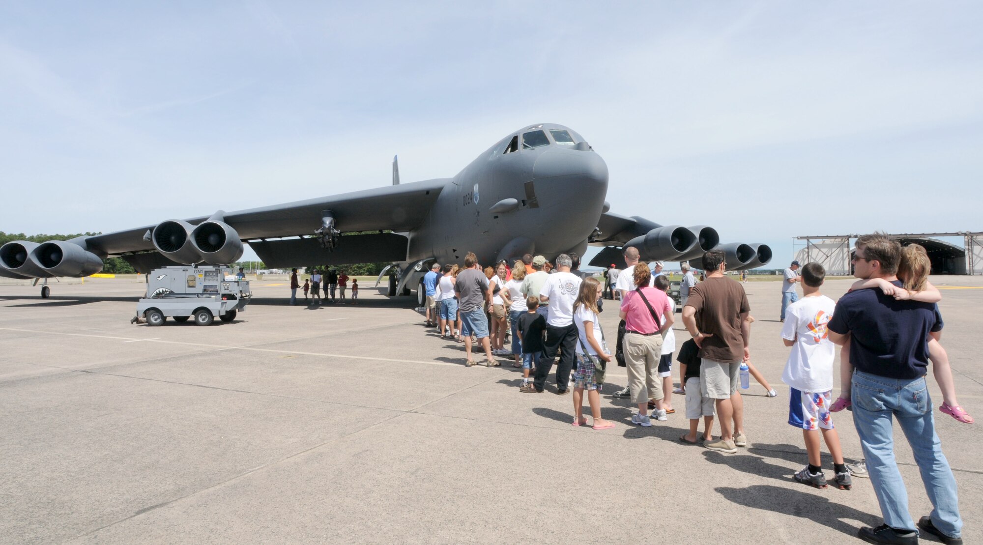 Spectators line up in front of a B-52 chalked at Bradley Air National Guard Base, East Granby, Conn. to get a glimpse inside the cockpit during the 11th annual Space and Aviation Day Aug. 14, 2010. The event drew more than 4,500 people throughout the day who came from near and far to see various static aircraft, enjoy arts and crafts and ride in a tethered air balloon. Also, funds and awareness were raised for the Hole in the Wall Gang Camp in Ashford. (U.S. Air Force photo by Tech. Sgt. Erin McNamara)