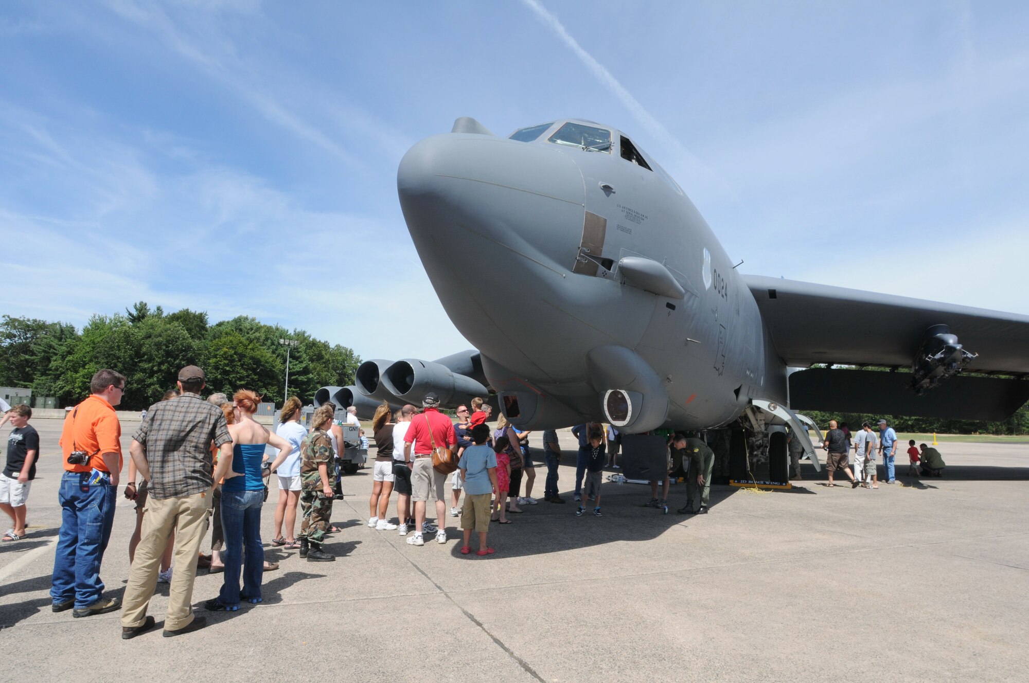 Spectators line up in front of a B-52 chalked at Bradley Air National Guard Base, East Granby, Conn. to get a glimpse inside the cockpit during the 11th annual Space and Aviation Day Aug. 14, 2010. The event drew more than 4,500 people throughout the day who came from near and far to see various static aircraft, enjoy arts and crafts and ride in a tethered air balloon. Also, funds and awareness were raised for the Hole in the Wall Gang Camp in Ashford. (U.S. Air Force photo by Tech. Sgt. Erin McNamara)