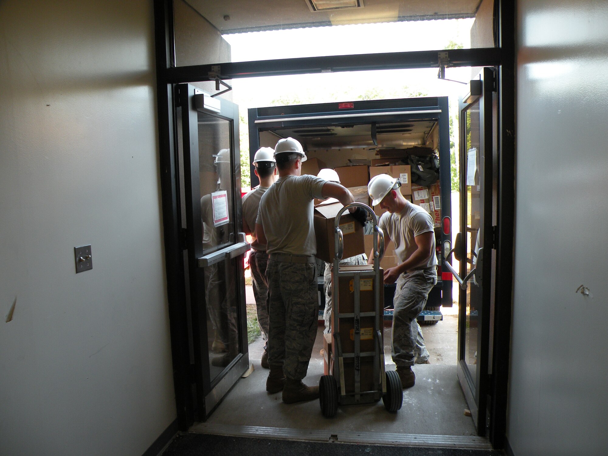 Members of the 103rd  Air and Space Operations Group work together at Bradley Air National Guard Base, East Granby, Conn. with the 118th Airlift Squadron’s Life Support section Aug. 26, 2010, to move equipment and other gear in preparation for construction efforts. (U.S. Air Force photo by Staff Sgt. Hope Morris)