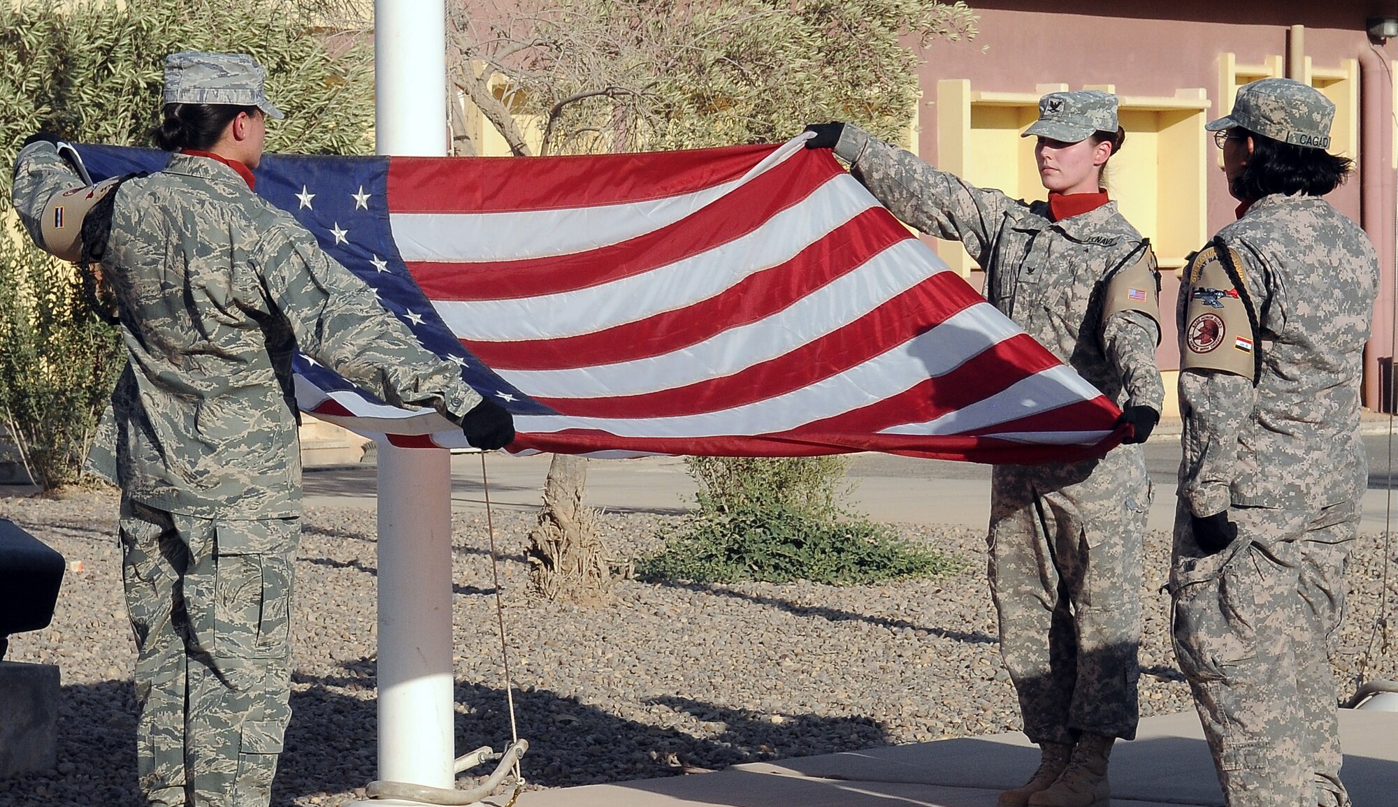 Members of the 332nd Air Expeditionary Wing Honor Guard prepare to fold the American Flag in a 9-11 remembrance retreat ceremony Sept. 11, 2010, Joint Base Balad, Iraq. On this ninth anniversary of the attack on America, ceremonies such as these remind service members what they are fighting for in Iraq, said Col. Christopher Craige, 332nd Air Expeditionary Wing vice commander. (U.S. Air Force photo/Senior Airman Marianne E. Lane)
