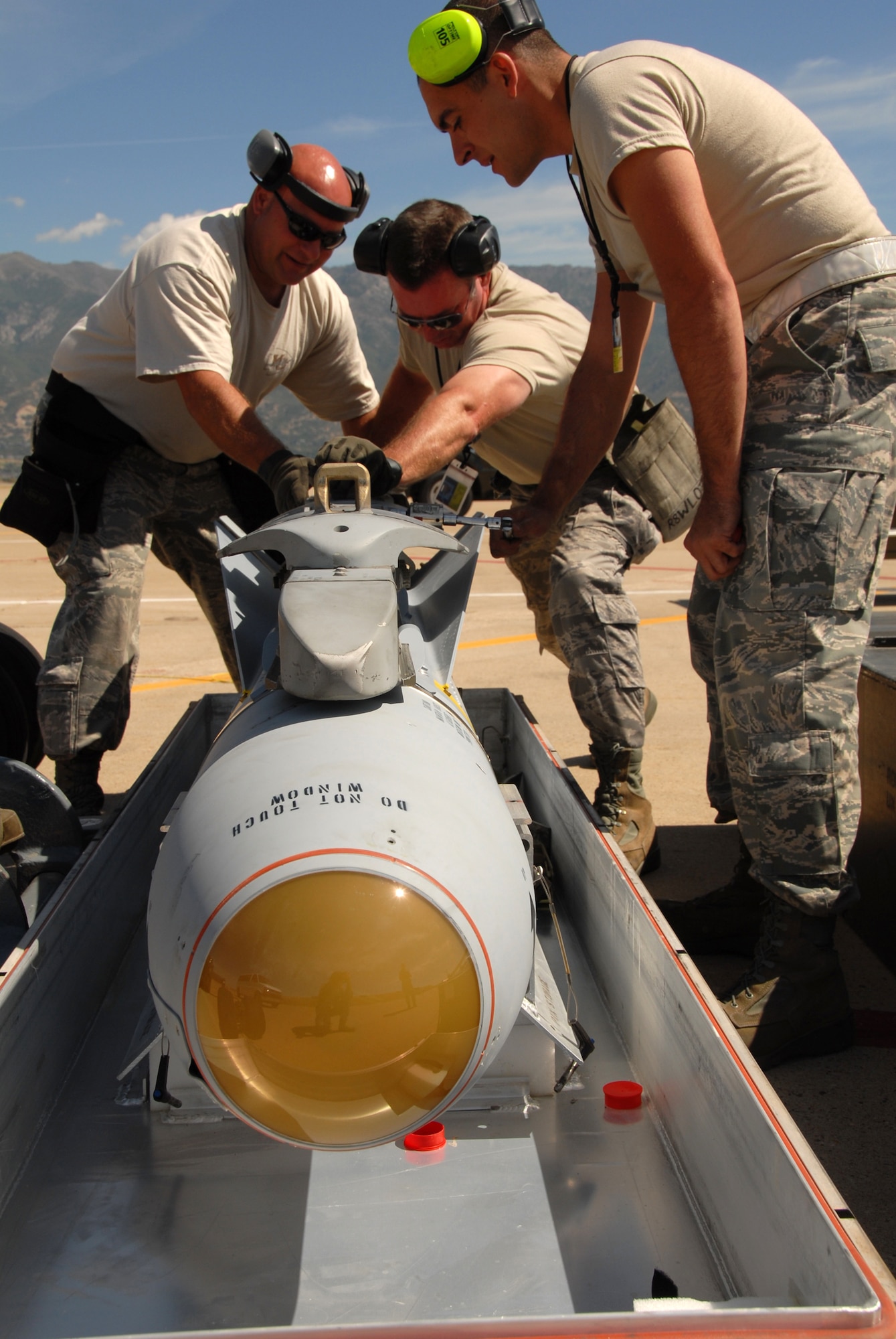 Tech. Sgt. Butch Portell, Master Sgt. James Kirksey and Staff Sgt. Kenneth Meadows fit a launcher onto a live AGM-65 Maverick missile so it can be loaded onto an A-10C Thunderbolt II at Hill Air Force Base, Utah, Aug. 31. The three Airmen are from the 442nd Maintenance Group, part of the 442nd Fighter Wing, based at Whiteman Air Force Base, Mo.  They were part of a 70-person deployment with six aircraft that supported live-fire weapons training for the wing's pilots at the Utah Test and Training Range.  The 442nd FW is an Air Force Reserve unit.  (U.S. Air Force photo/Lt. Col. David Kurle)