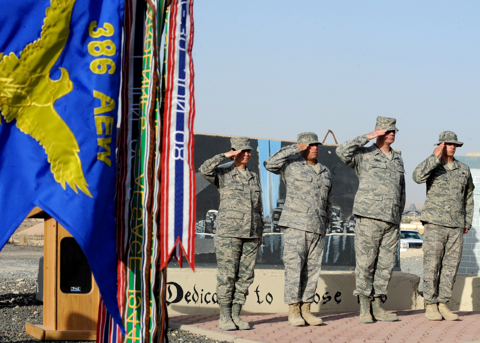 SOUTHWEST ASIA - Airmen from the 386th Air Expeditionary Wing salute as Taps is played during a 9/11 wreath-laying ceremony at an undisclosed air base here Sept. 11, 2010. The service was held in tribute to the nearly 3,000 fallen men and women who lost their lives during terrorist attacks on the United States on Sept. 11, 2001. (U.S. Air Force photo by Senior Airman Laura Turner)