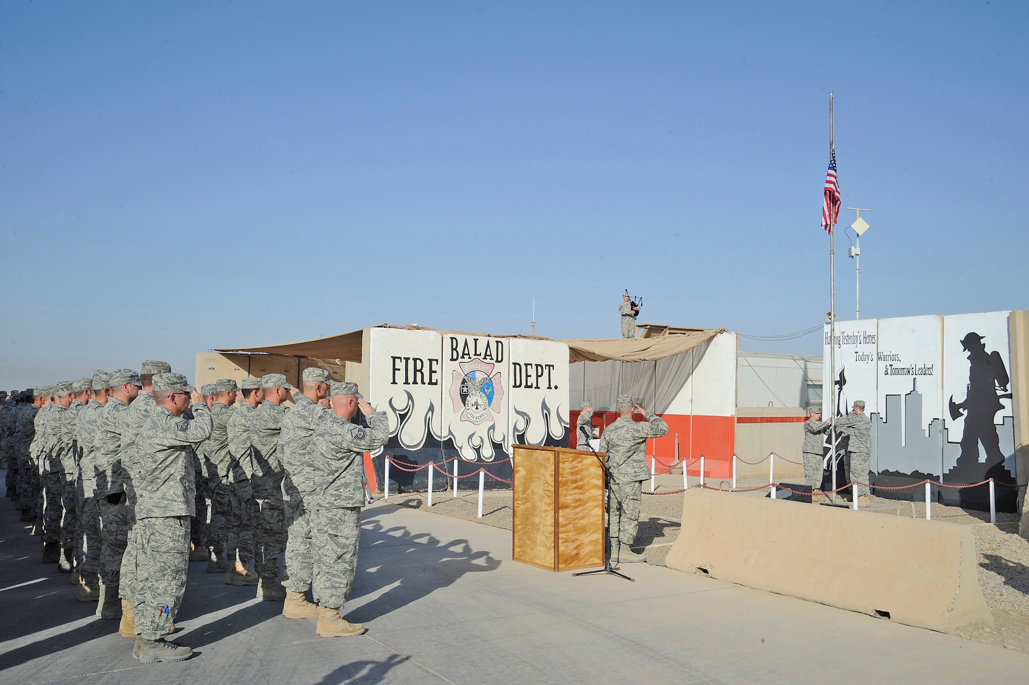 Fire Fighters from the 332nd Expeditionary Civil Engineer Squadron, gather in remembrance of the Sept. 11, 2001, attack on America, Joint Base Balad, Iraq Sept. 11, 2010. The fire department held a ceremony to remember their brothers in arms and others who perished on that day. (U.S. Air Force photo/ Senior Airman Matt Coleman-Foster)