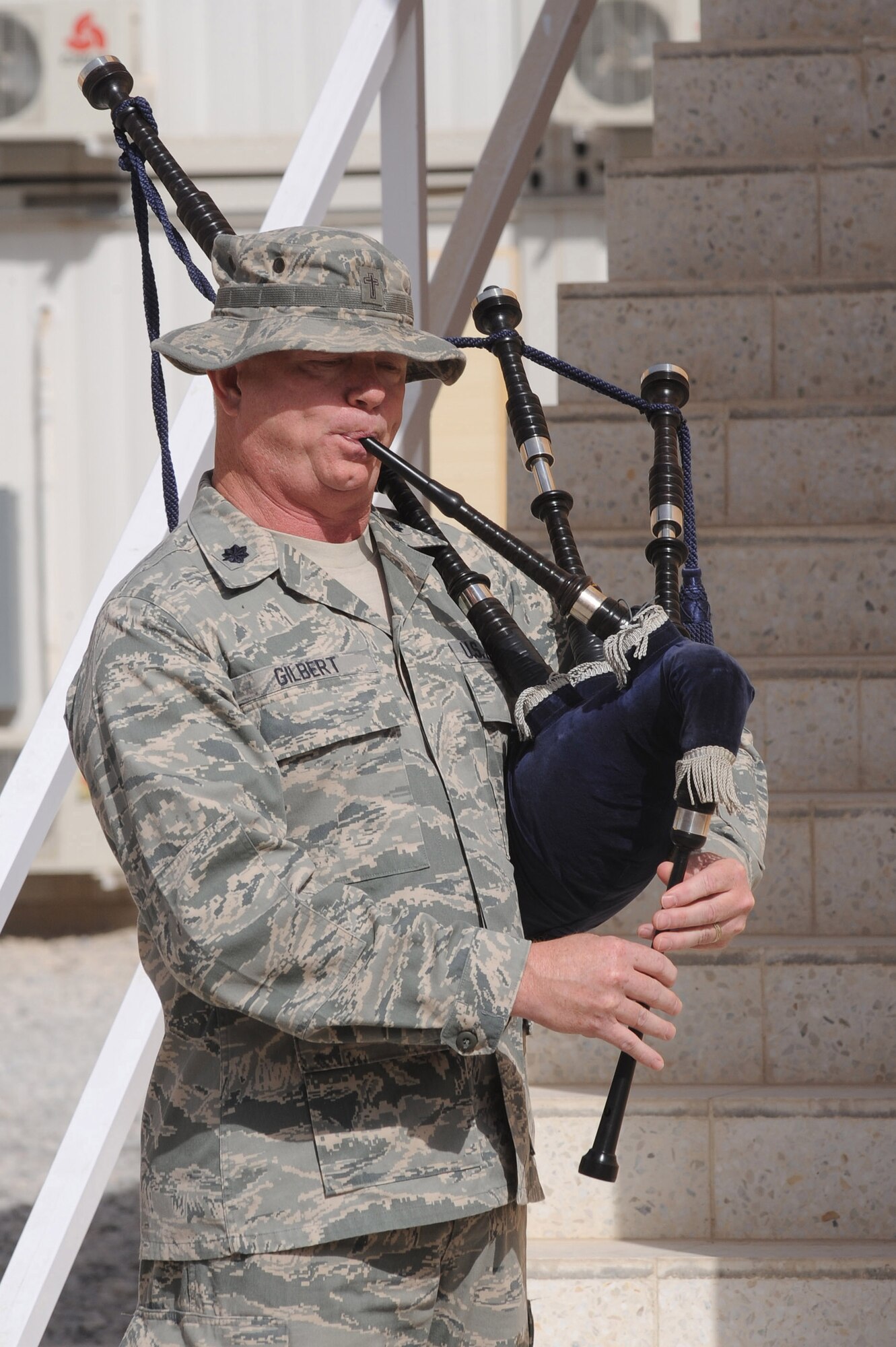 Chap. (Lt. Col.) Michael Gilbert plays taps after the lowering of the American flag to half-staff at the 9/11 memorial ceremony Sept. 11, 2010, at Kandahar Airfield, Afghanistan. This is the ninth anniversary of the day 2,998 individuals perished during a terrorist attack. (U.S. Air Force photo by Tech. Sgt. Chad Chisholm/Released)
