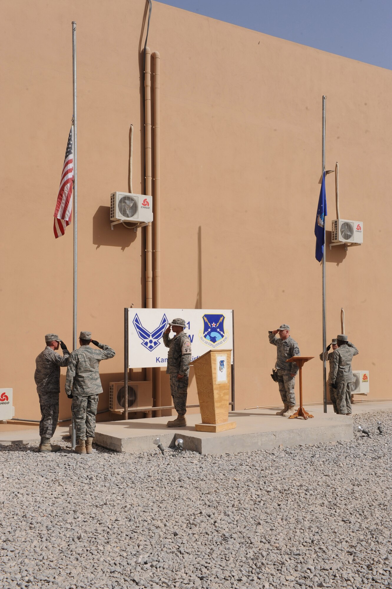 The 451st Air Expeditionary Wing Honor Guard salutes the American flag at half-staff during the 9/11 memorial ceremony, Sept. 11, 2010, at Kandahar Airfield, Afghanistan. This is the ninth anniversary of the day 2,998 individuals perished during a terrorist attack. (U.S. Air Force photo by Tech. Sgt. Chad Chisholm/Released)
