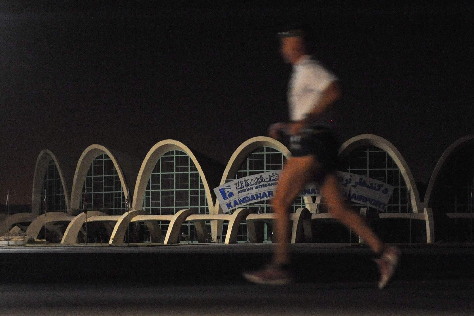 U.S. Navy Command Master Chief Lee True runs past the Kandahar International Airport during the Air Force Marathon Sept. 11, 2010, at Kandahar Airfield, Afghanistan.  Master Chief True is assigned to the Kandahar Role 3 Hospital.  (U.S. Air Force photo by Tech. Sgt. Chad Chisholm/Released)