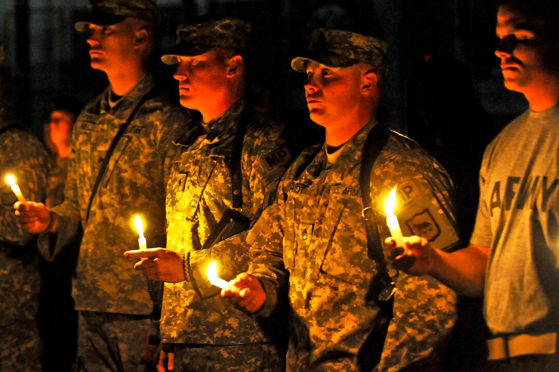 U.S. Army soldiers hold candles in memory of 9/11 victims during a vigil on Camp Phoenix, Afghanistan, Sept. 11, 2010. More than 200 soldiers, sailors, airmen, Marines and civilians attended the ceremony.