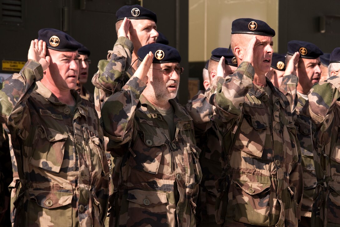 A formation of French soliders from Task Force La Fayette render a salute while singing "La Marseillaise", the French national anthem, in a ceremony on Forward Operating Base Morales-Frazier, Kapisa province, Afghanistan, Sept. 11, 2010, 
commemorating the 9/11 terrorist attacks on the United States.