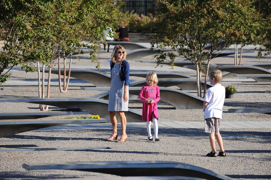 Families of the fallen walk among the Pentagon Memorial benches on Sept. 11, 2010 - one bench for each of the 184 people who died at this spot 9 years ago.  Many of the children were too young to have any memory of the terrible day itself, but not today came to hear the President of the United States eulogize their relative and say that as we confront the spector of terrorism "we will not sacrifice the liberties we cherish or hunker down behind walls of suspicion and mistrust."  