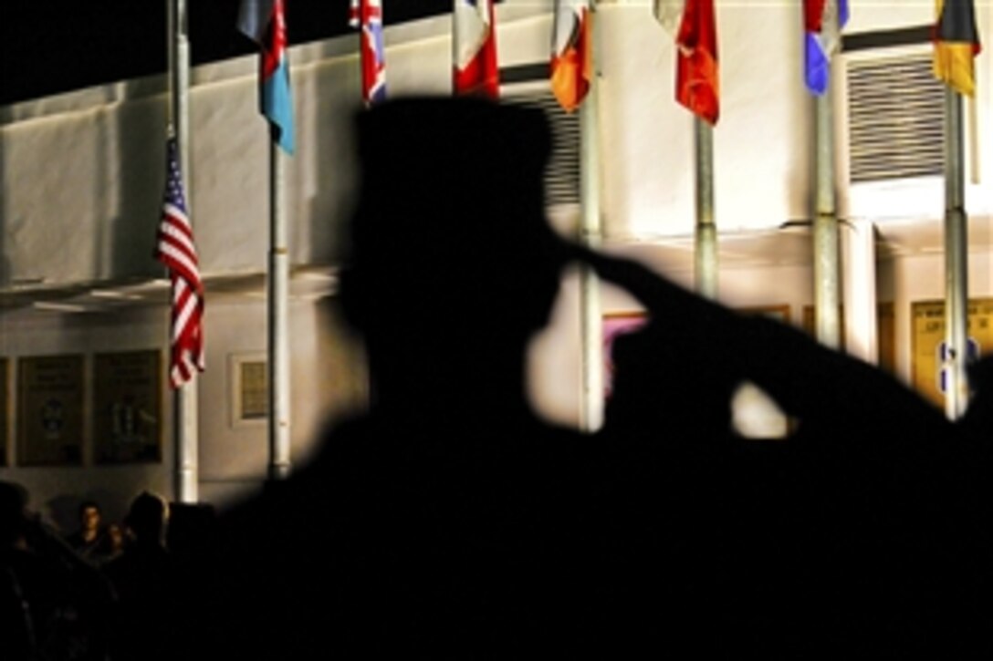 U.S. troops salute the flag during a 9/11 vigil on Camp Phoenix, Afghanistan, Sept. 11, 2010.  More than 200 soldiers, sailors, airmen, Marines and civilians attended the ceremony.