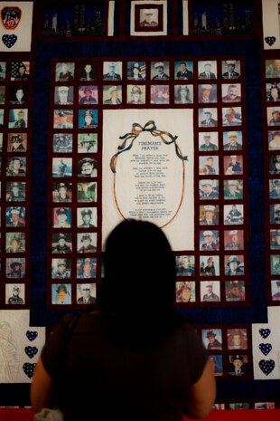 A woman looks at a 9/11 tribute quilt before an annual memorial luncheon held for him on the anniversary of his death, New York, Sept 11. Bucca is the only fire marshal killed in the line of duty. (Official Marine Corps photo by Sgt. Randall A. Clinton)