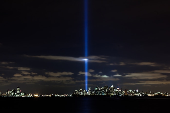 A light display shines from where the World Trade Center used to be, New York, Sept. 11. The two beams of light are illuminated each year on the anniversary of the 9/11 attacks. Ronald Bucca, a New York fire marshal, died on in the attack. On the ninth anniversary of his death his family was presented with a flag from the former Iraq detention facility bearing his name. (Official Marine Corps photo by Sgt. Randall A. Clinton / RELEASED)