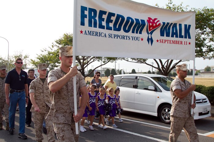 Marines, sailors and dependents walk to the Marine Memorial Chapel during the Sept. 11 Freedom Walk here Saturday. The Freedom Walk is done to remember and honor those who lost their lives during the Sept. 11, 2001, terrorists attacks.