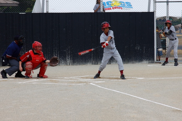 Shawn Eagman, sophomore pitcher, connects with the ball during a regular season baseball game against Sasebo’s Ernest J. King Cobras at the main field here Saturday. After receiving a gut-wrenching 12-10 loss Sept. 10, the Samurai regrouped and ousted the Cobras 10-1.
