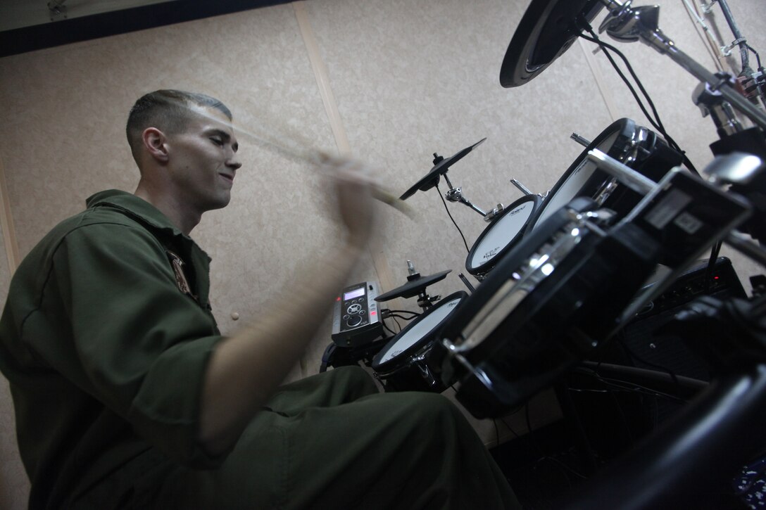 Lance Cpl. Trenton Brown, a diesel engine mechanic with Marine Medium Tiltrotor Squadron 266 (Reinforced), 26th Marine Expeditionary Unit, plays the drums for a Sunday church service aboard USS Kearsarge, Sept. 12, 2010. 26th MEU deployed aboard the ships of Kearsarge Amphibious Ready Group in late August responding to an order by the Secretary of Defense to support Pakistan flood relief efforts.