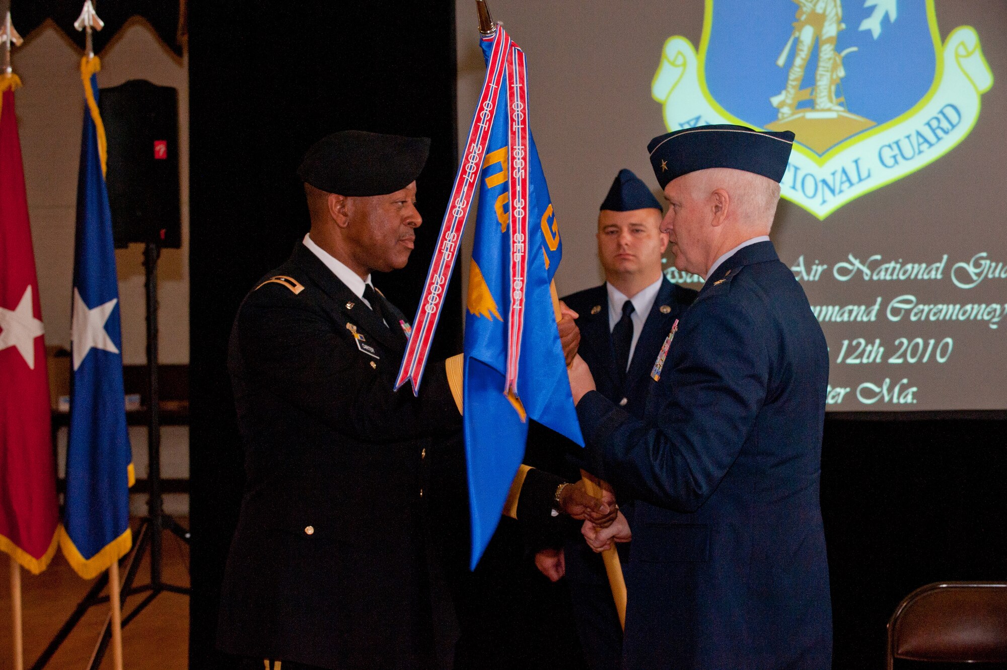 Brig. Gen. L. Scott Rice, Incoming Commander, Massachusetts Air National Guard, accepts the colors from Maj. Gen. Joseph C. Carter, The Adjutant General, Massachusetts National Guard during a change of command ceremony held at the National Guard Museum in Worcester on September 12, 2010. (Photo by Technical Sgt. Eric Klein) 