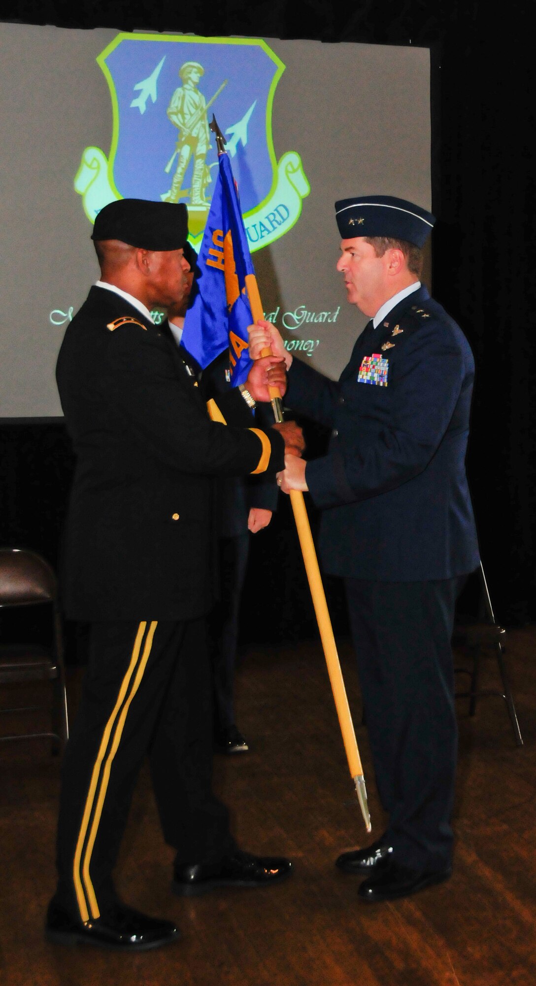 Maj. Gen. Michael D. Akey, outgoing Commander Massachusetts Air National Guard passes the colors to Maj. Gen. Joseph C. Carter, The Adjutant General, Massachusetts National Guard during a change of command ceremony held at the National Guard Museum in Worcester Mass. on September 12, 2010. (U.S. Air Force photo by Senior Airman Eric Kolesnikovas)