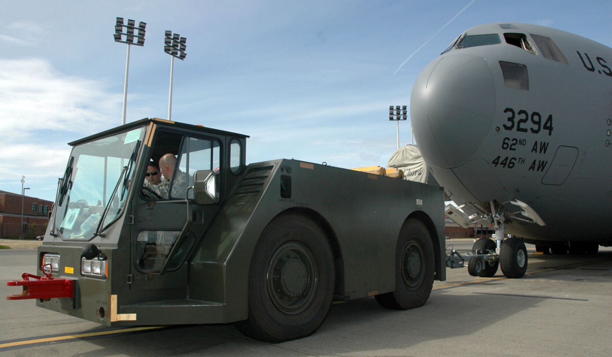 JOINT BASE LEWIS-MCCHORD, Wash. -- Tech Sgt. Merle Brooks (driver) and Master Sgt. Wayne Ruedinger (passenger) prepare to tow a C-17 Globemaster to a maintenance hangar during a UTA here Sept. 11, 2010.  Sergeant Brooks is a crew chief and Sergeant Ruedinger is a guidance and control specialist. Both Airmen are Reservists with the 446th Aircraft Maintenance Squadron. (U.S. Air Force photo/Staff Sgt. Grant Saylor)