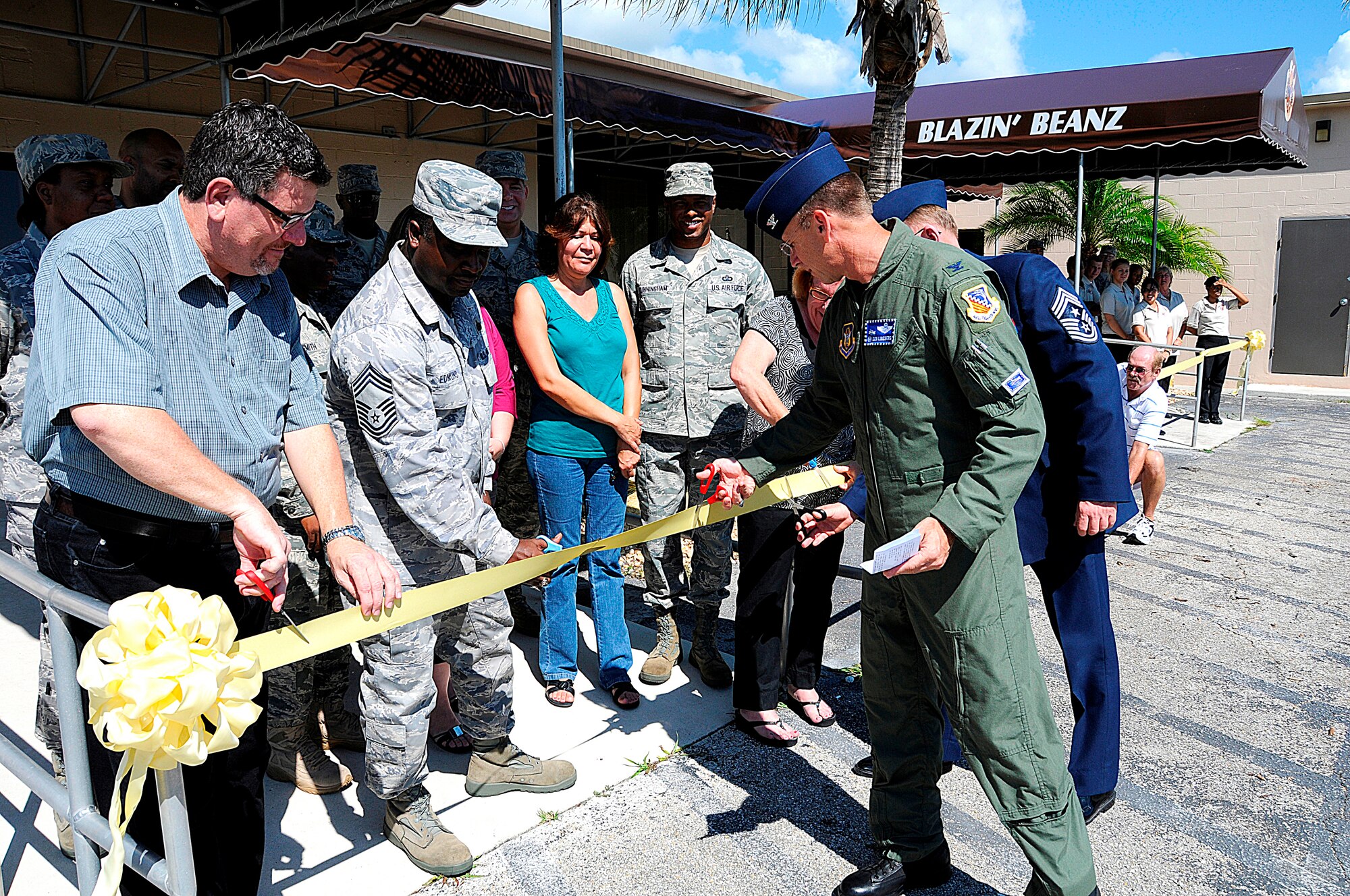 Col. Donald R. Lindberg, 482nd Fighter Wing commander cuts a ribbon to officially open the Blazen Beans Coffee Shop and the newly renovated Hair Care Center on Sep. 12.  The coffee shop is open Monday thru Friday, 6 a.m. until 6 p.m., and on Unit Training Assembly weekends as well.  The Hair Care Center is open Monday thru Friday, 8:30 a.m. until 5:30p.m., and Saturdays from 8:30 a.m. until 4 p.m. (U.S. Air Force photo/Tim Norton)