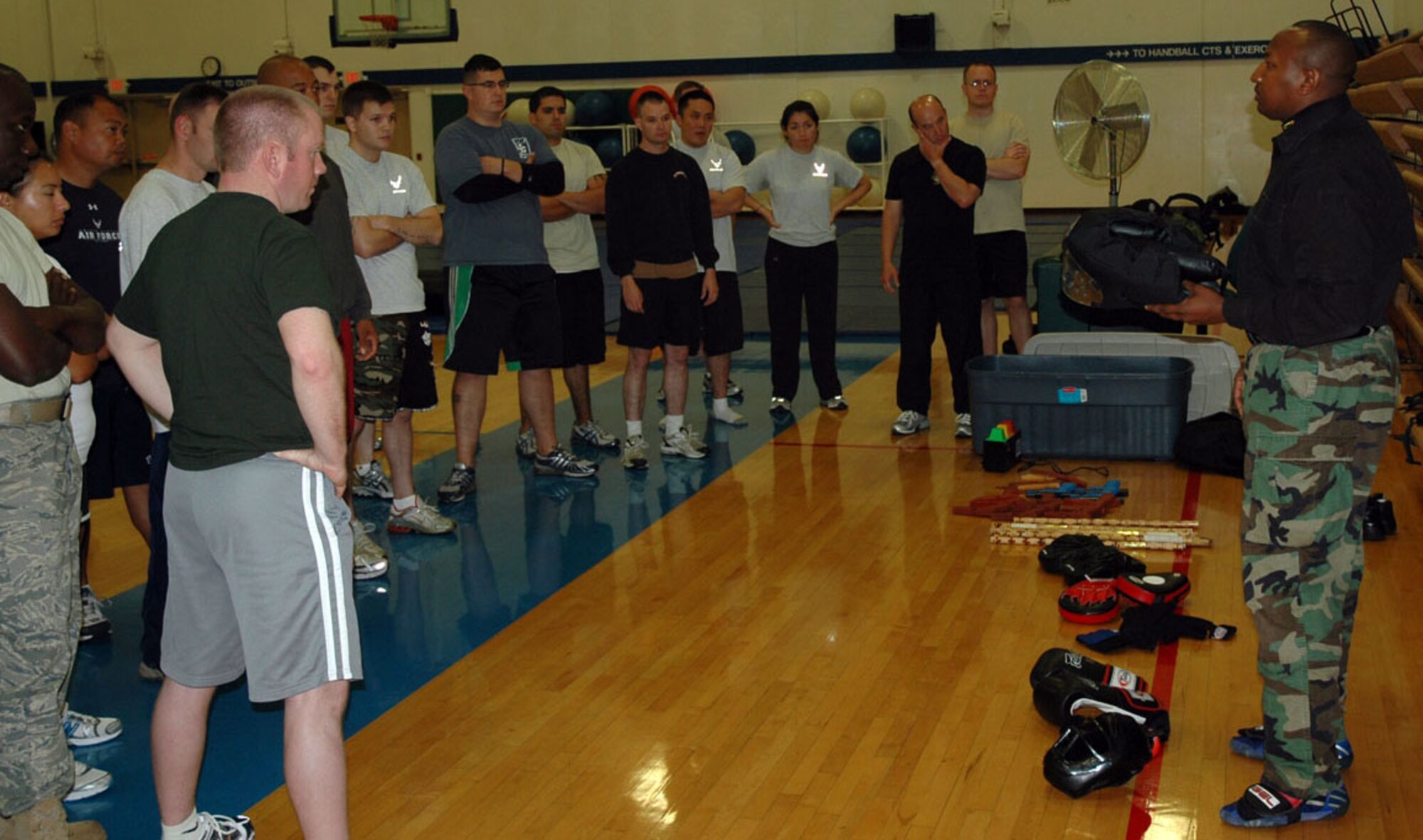 JOINT BASE LEWIS-MCCHORD, Wash. -- Master defensive tactic instructor Abdul Mohamed talks strategy with Reservists from the 446th Security Forces Squadron during a refresher training course here Sept. 12, 2010.  Mr. Mohamed is a former police officer and current defensive tactics training officer at the King County (Wash.) Jail.  (U.S. Air Force photo/Staff Sgt. Grant Saylor)