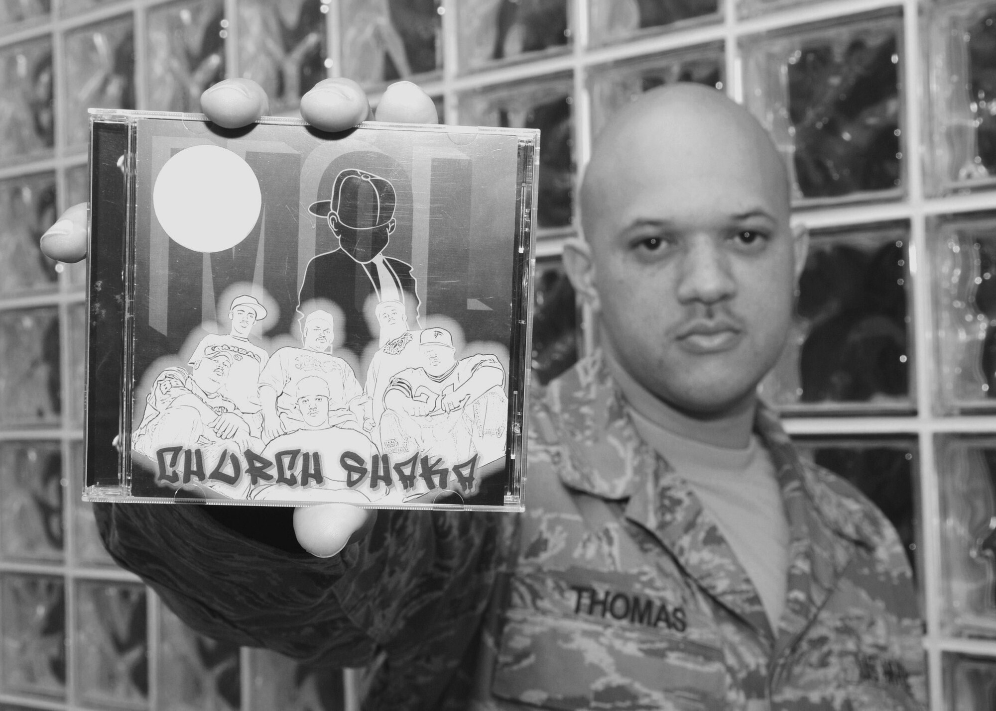 Tech Sgt. Lesley Thomas, a member of the 137 Air Refueling Wing's Finance Office, poses with his rap group's latest CD, "Church Shaka," by Mobsters of Light.  Sgt. Thomas says MOL performs across the country in churches, concerts, alternative schools and juvenile centers.